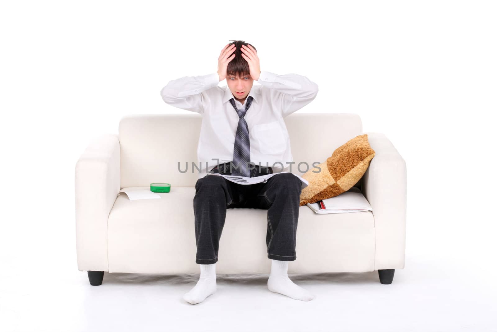 Shocked Teenager reads the book on the Sofa. Isolated on the white