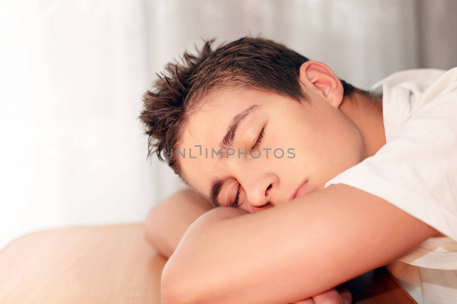 Young Man Sleeping on the Table in Home inerior