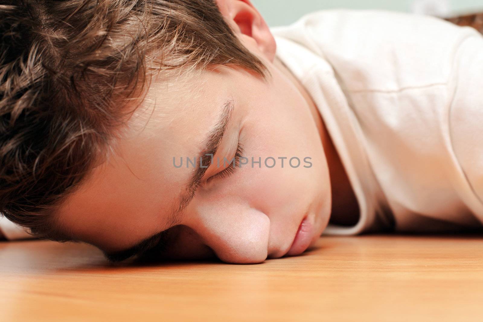 Young Man Sleeping on the Table in Home inerior