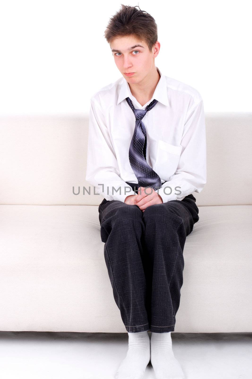 Shy Teenager on the Sofa isolated on the White background