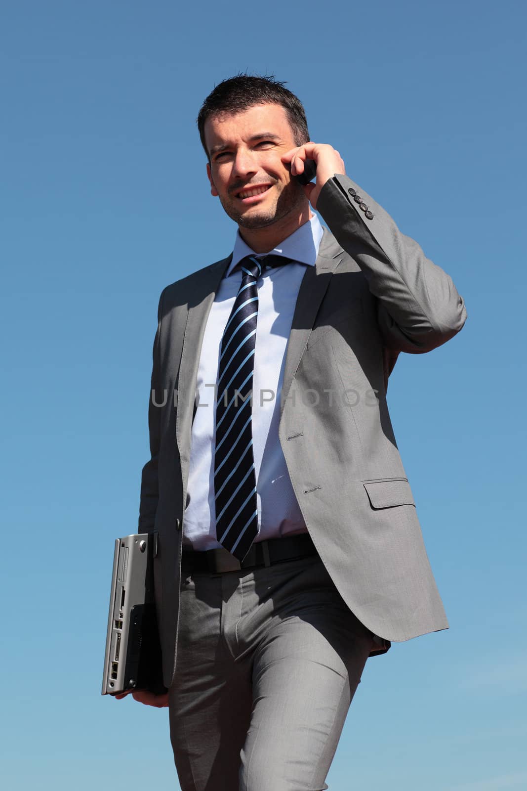 businessman on the phone in blue sky