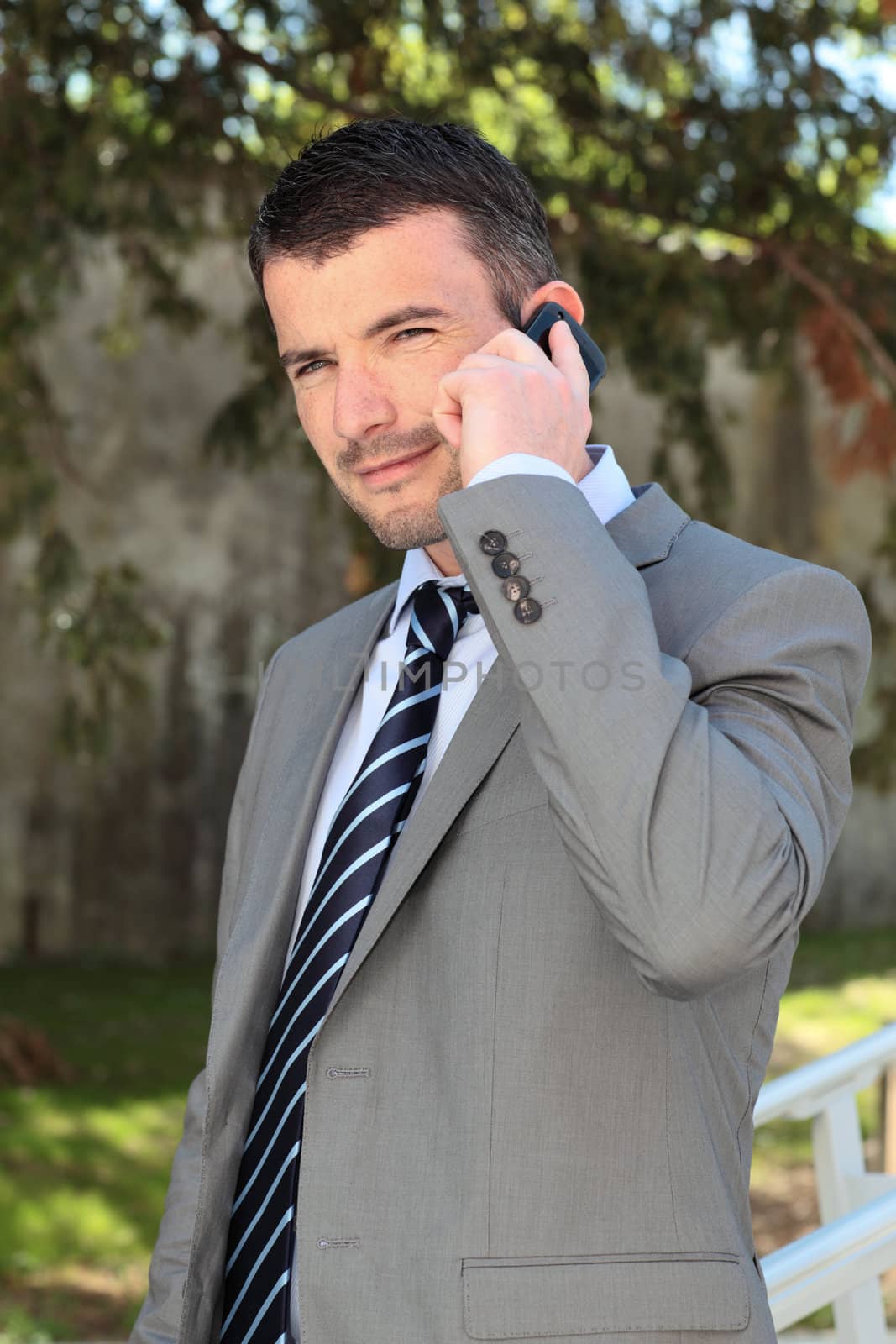 businessman on the phone outdoor in spring