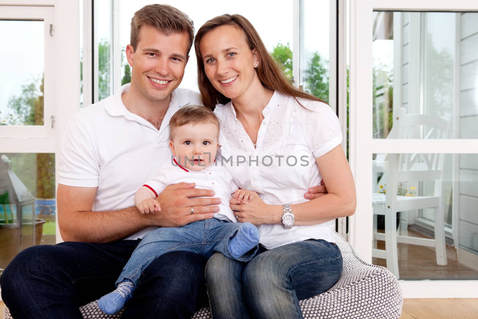 Portrait of a happy family looking at the camera in a home interior
