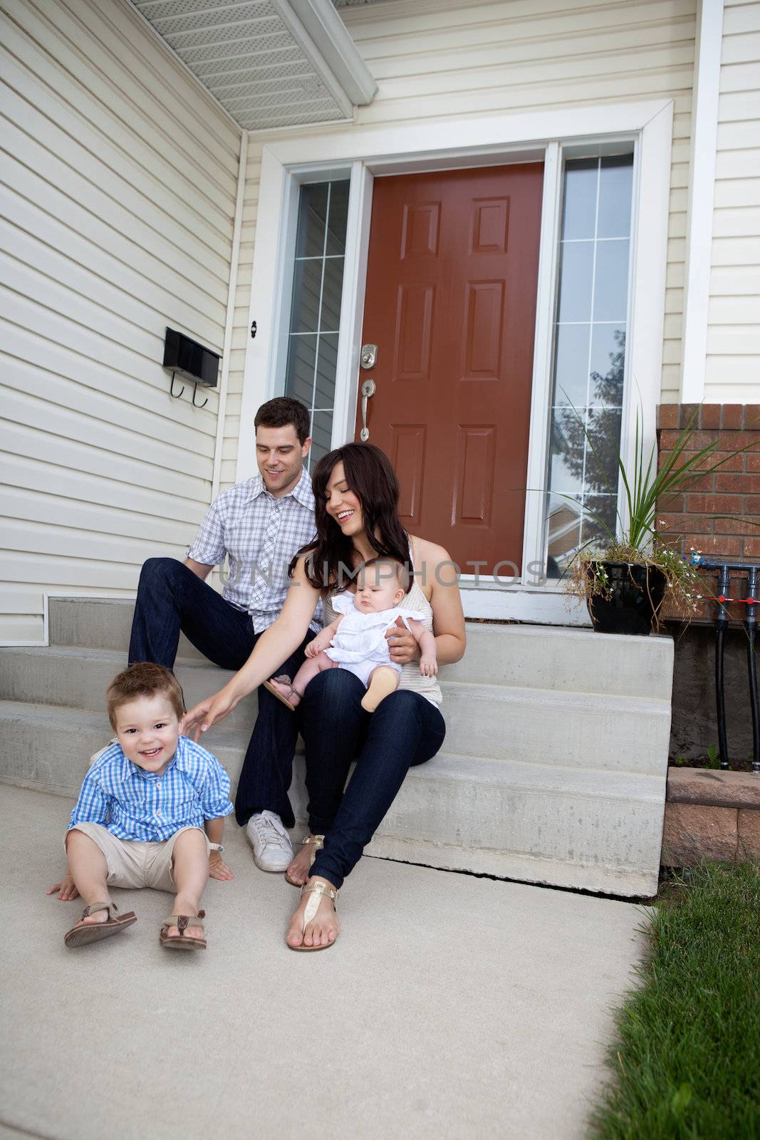 Family Sitting on Steps by leaf