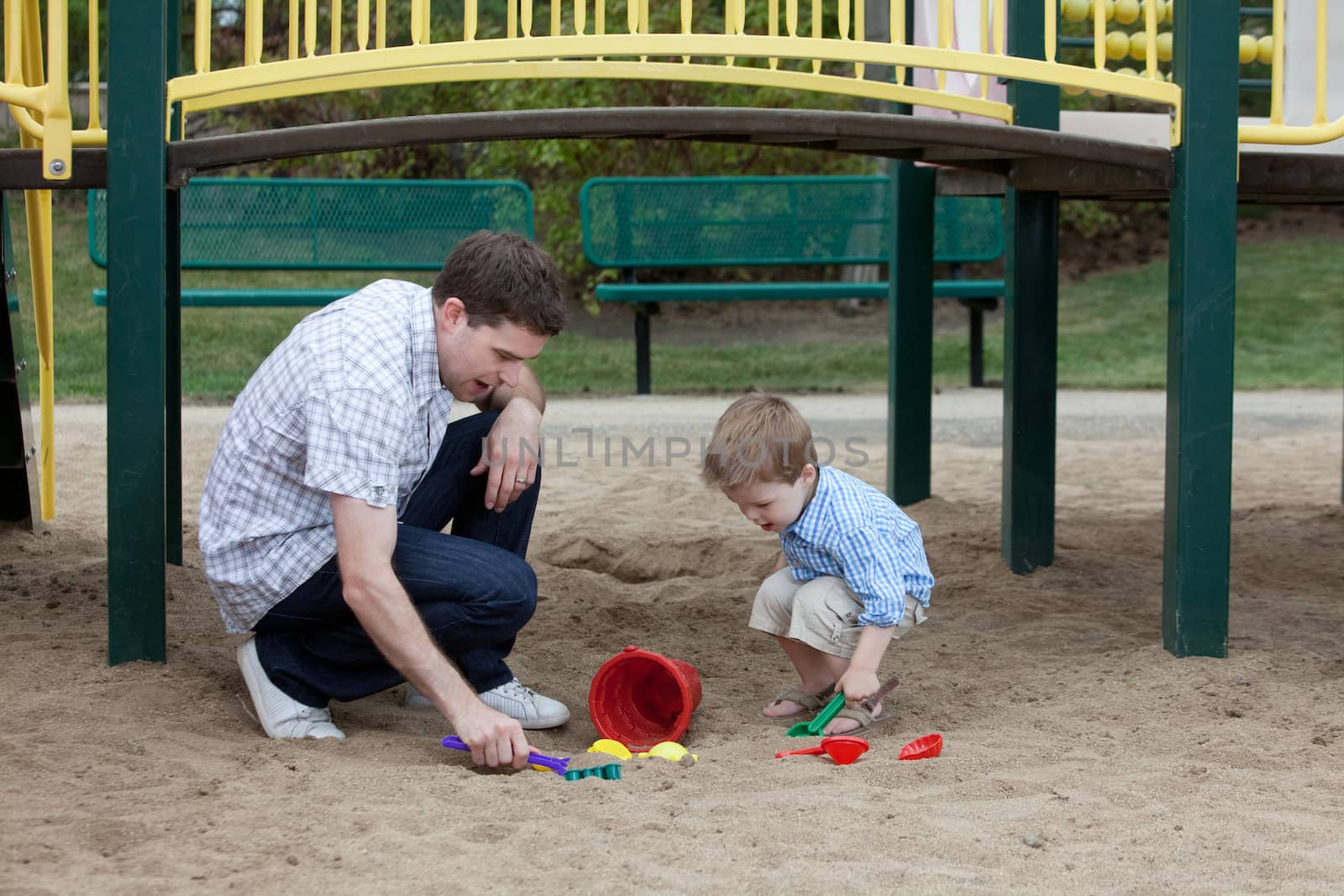 Happy Father And Son Playing At Playground In Sand With Toys.