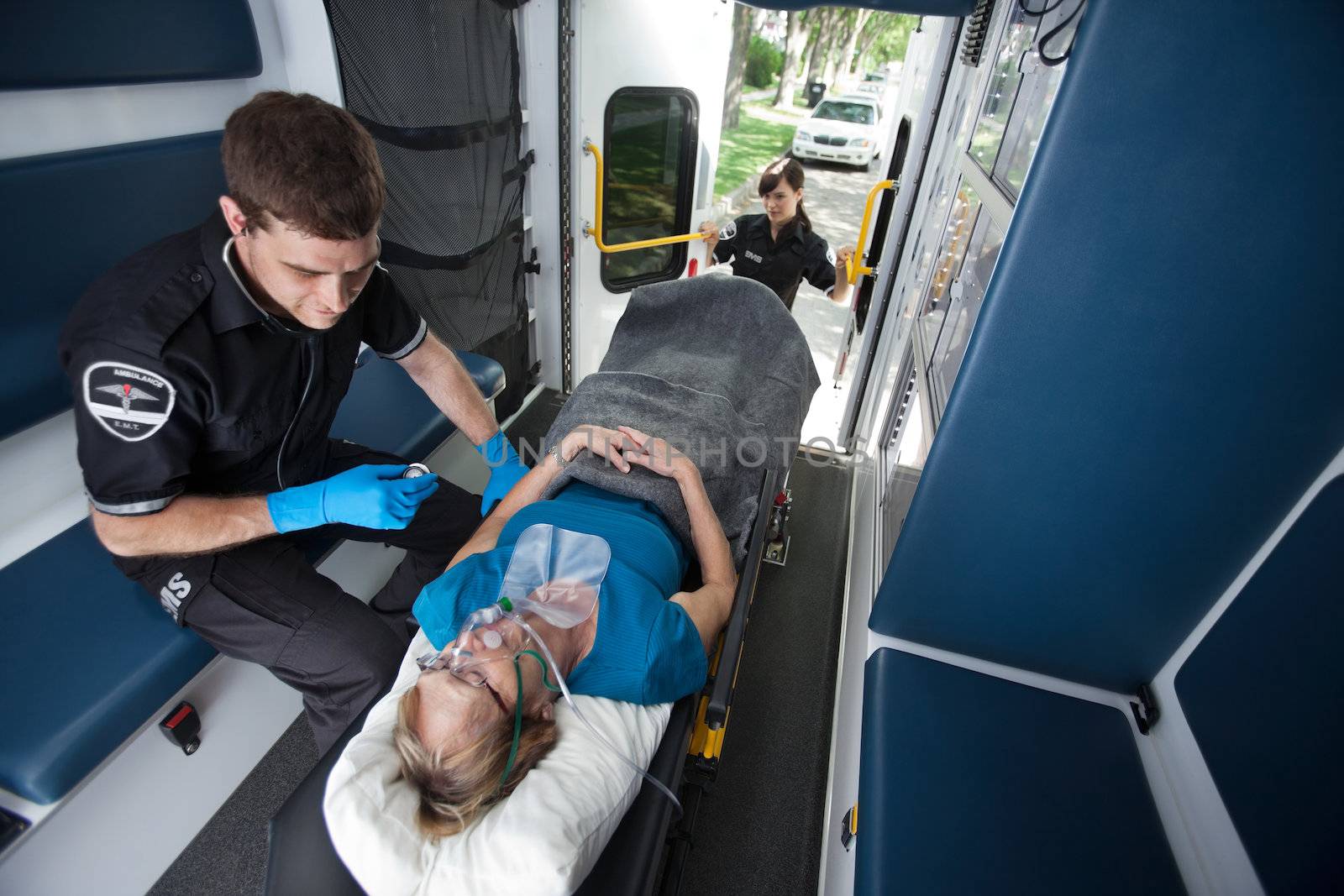 Emergency medical professionals  caring for senior patient