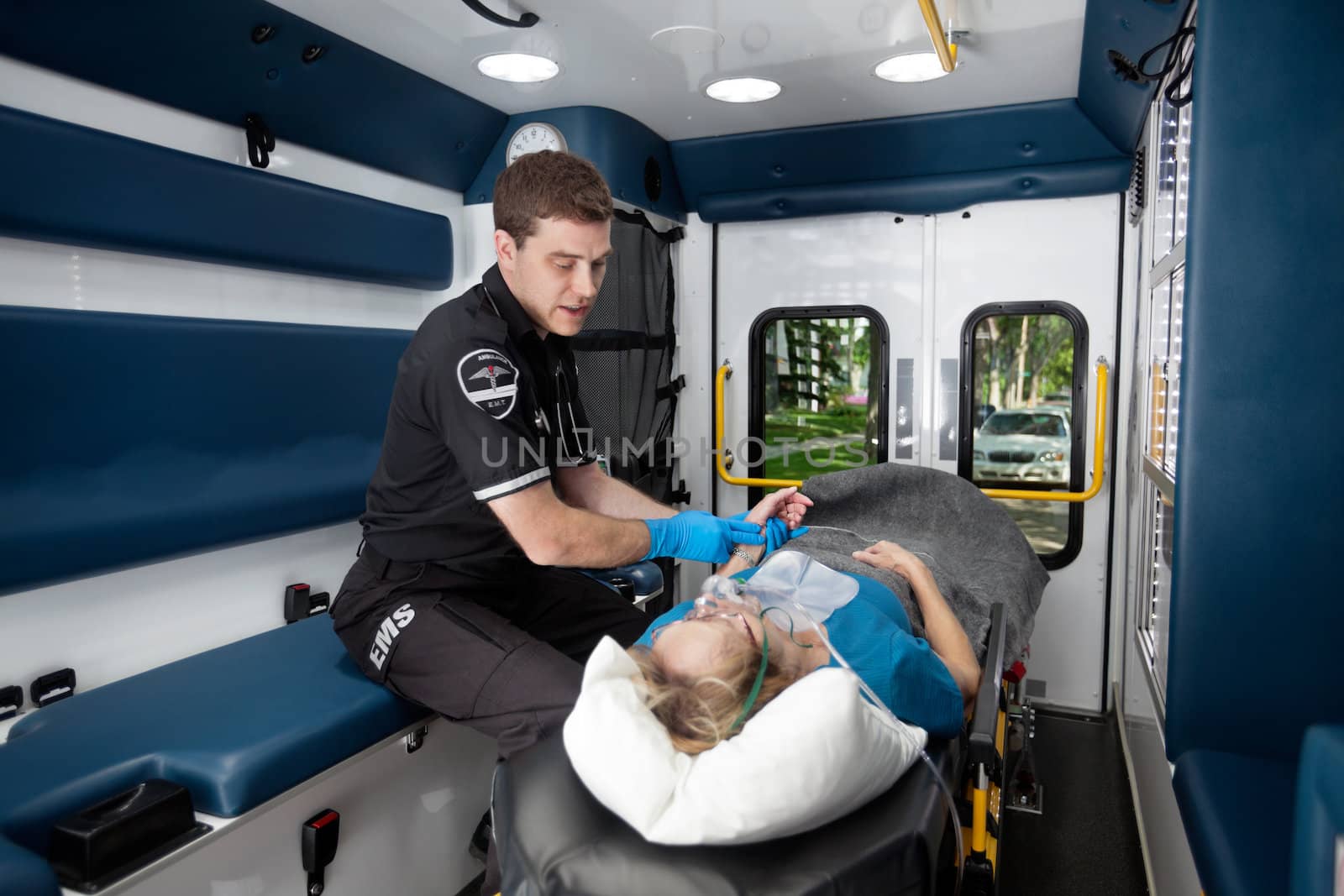 Ambulance professional with senior woman on stretcher