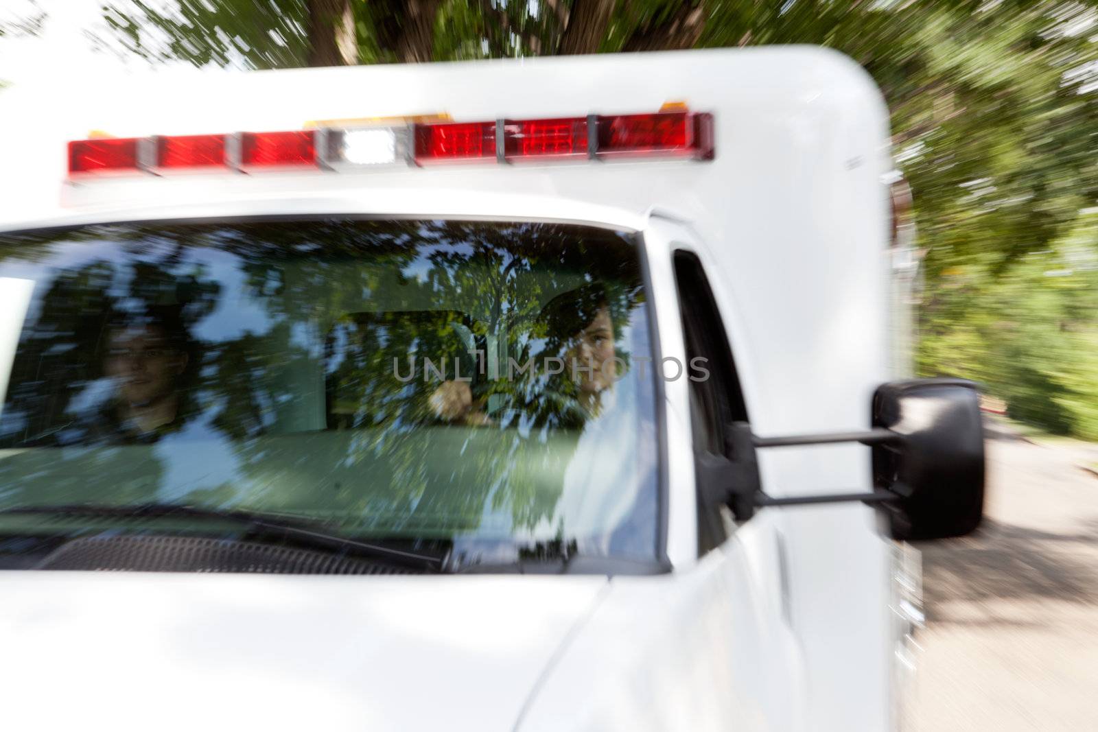 Motion blur of speeding ambulance with paramedic team