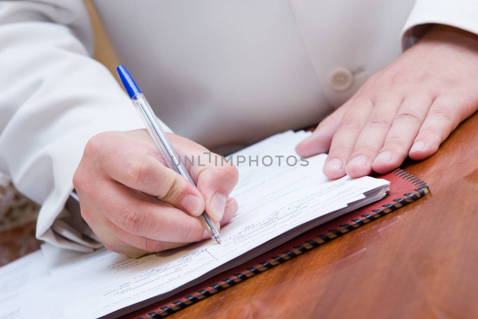 man signing paper by vsurkov