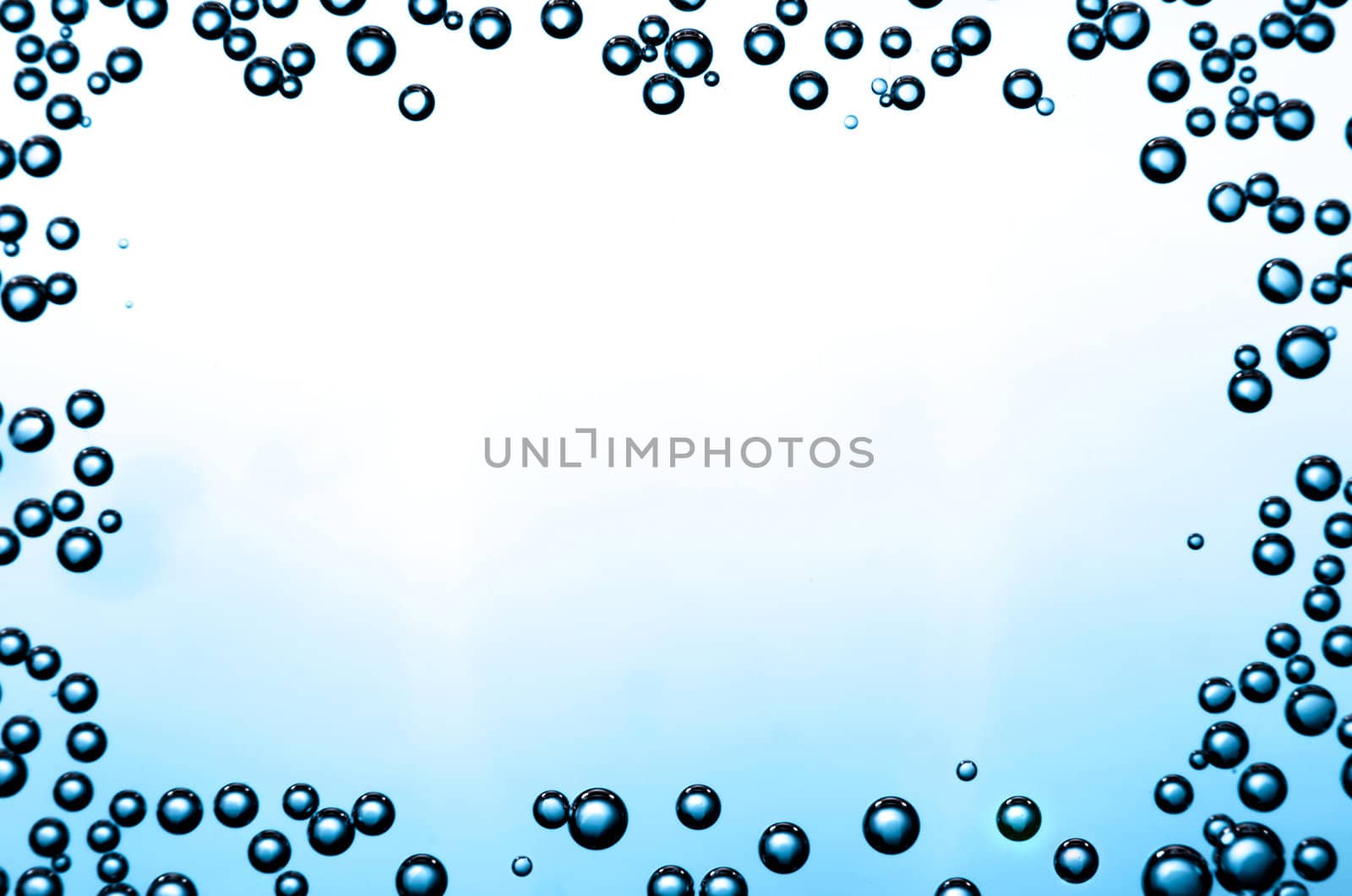 Gradient background with frame of bubbles on a glass.