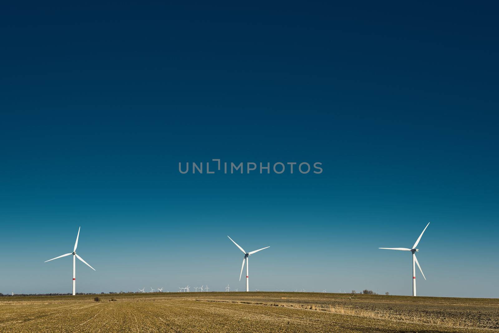 Windmills in northern Germany on a field on a sunny day