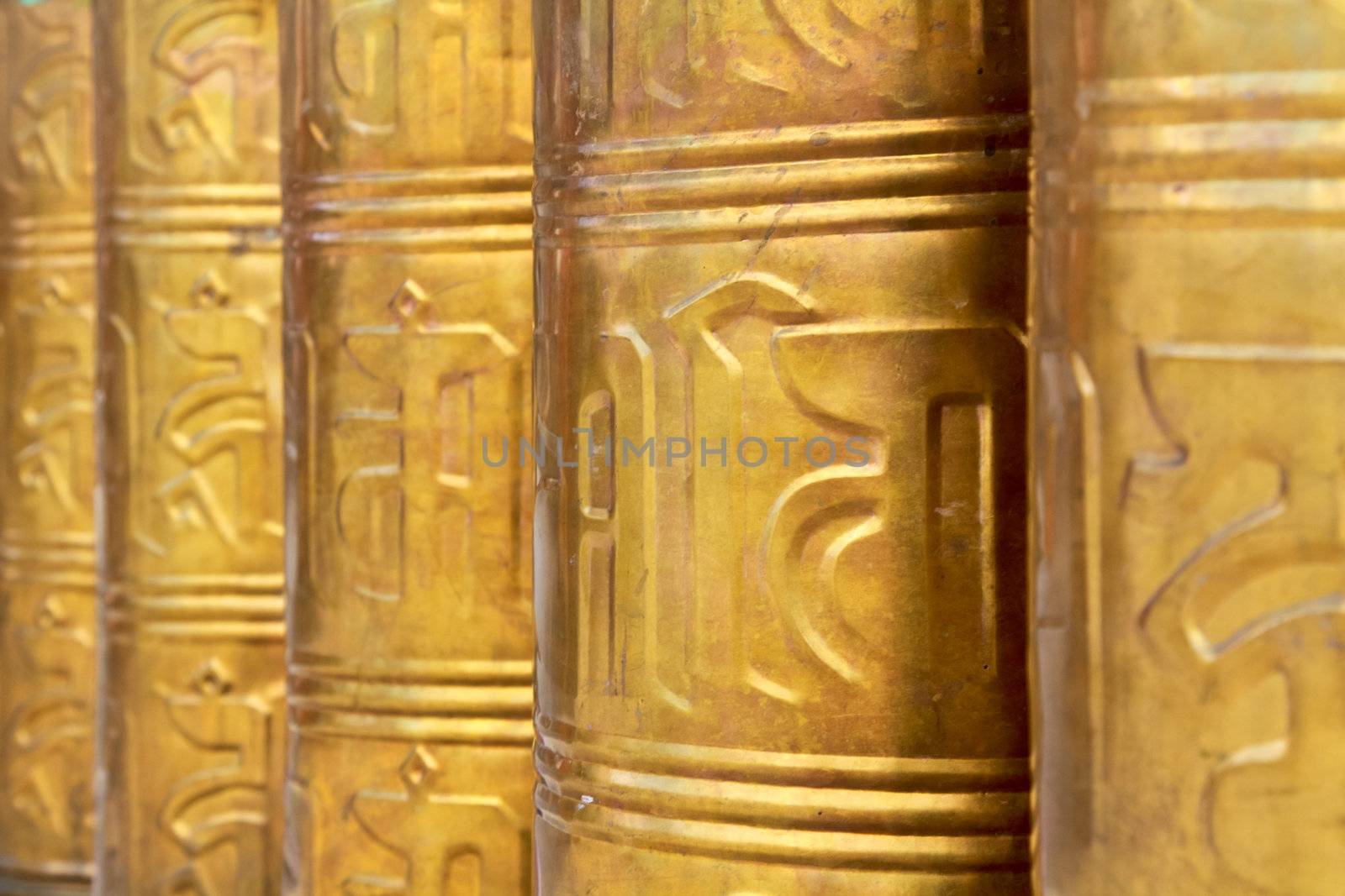 Buddhist prayer wheels decorated in Tibet monastery temple