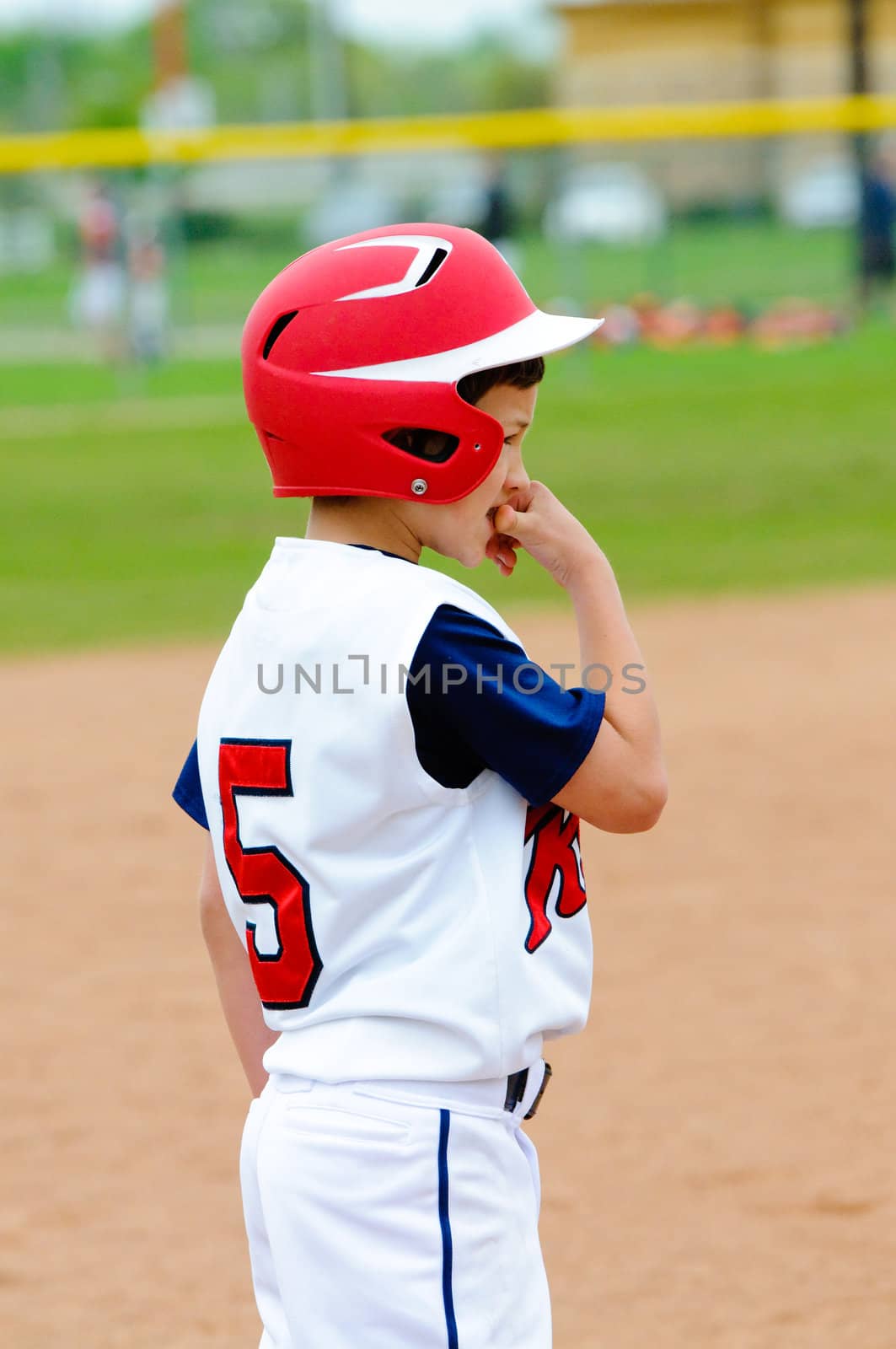 Llittle league player nervous on base.