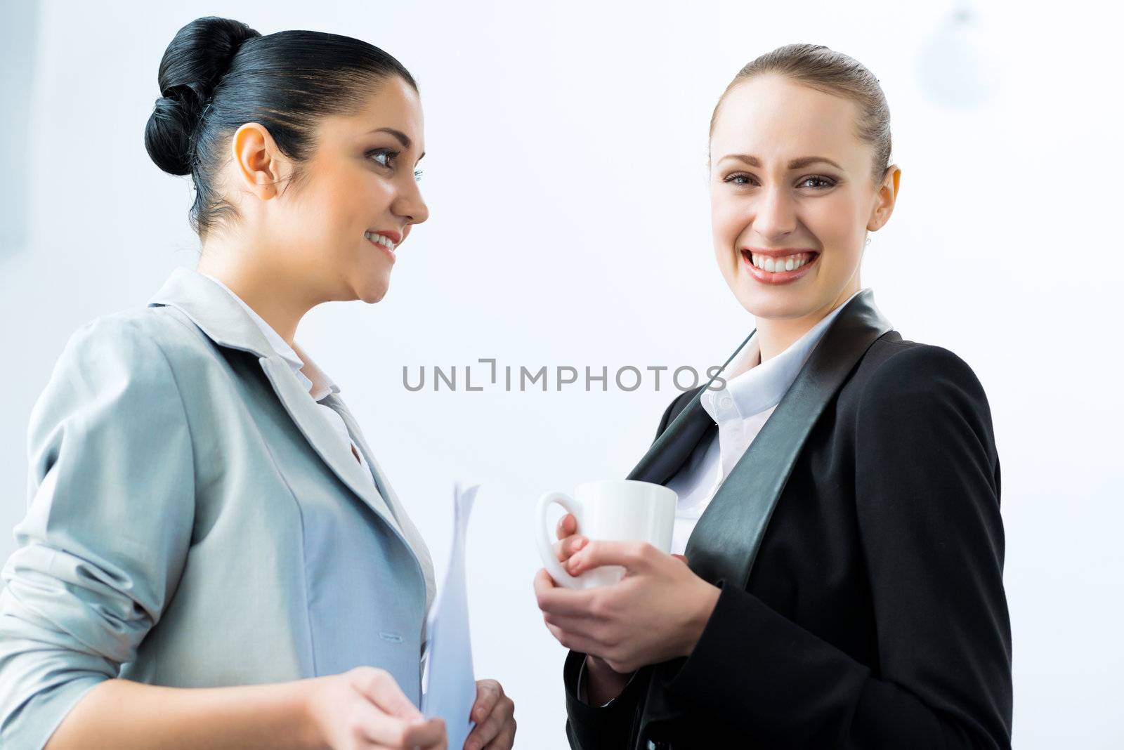 two business women discussing documents in the office