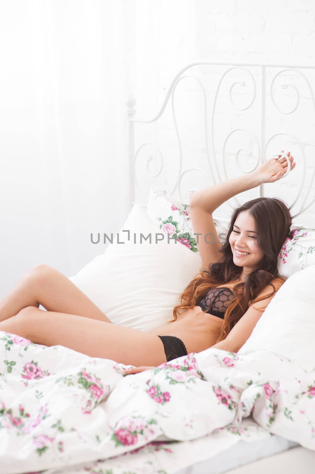a pretty young girl luxuriate in bed