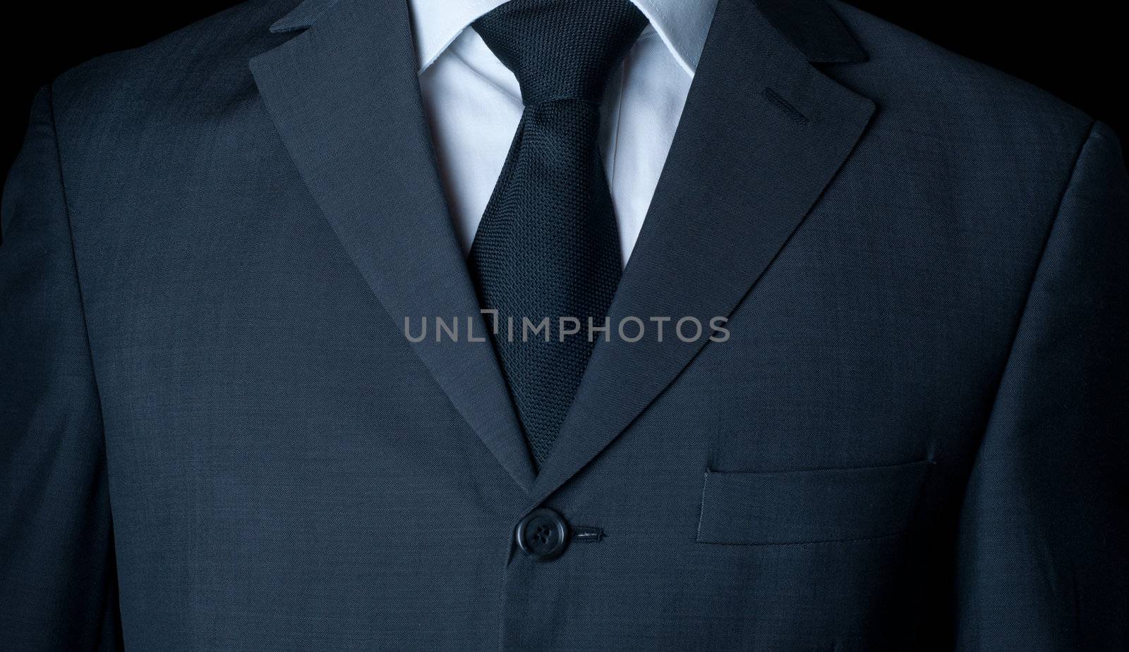 Closeup shot of business suit on a man, over dark background