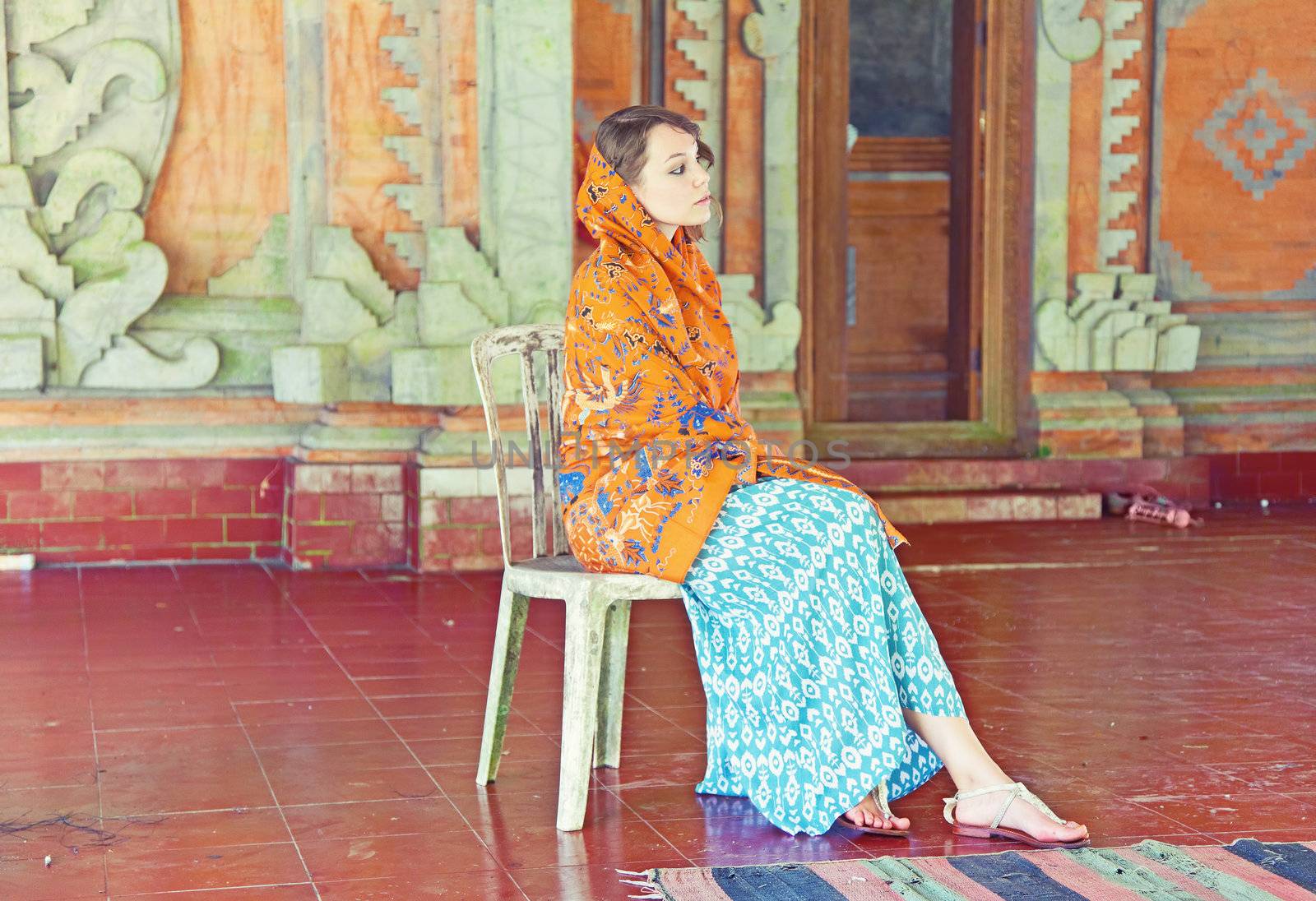 Woman on a old worn  chair. Bali. Indonesia