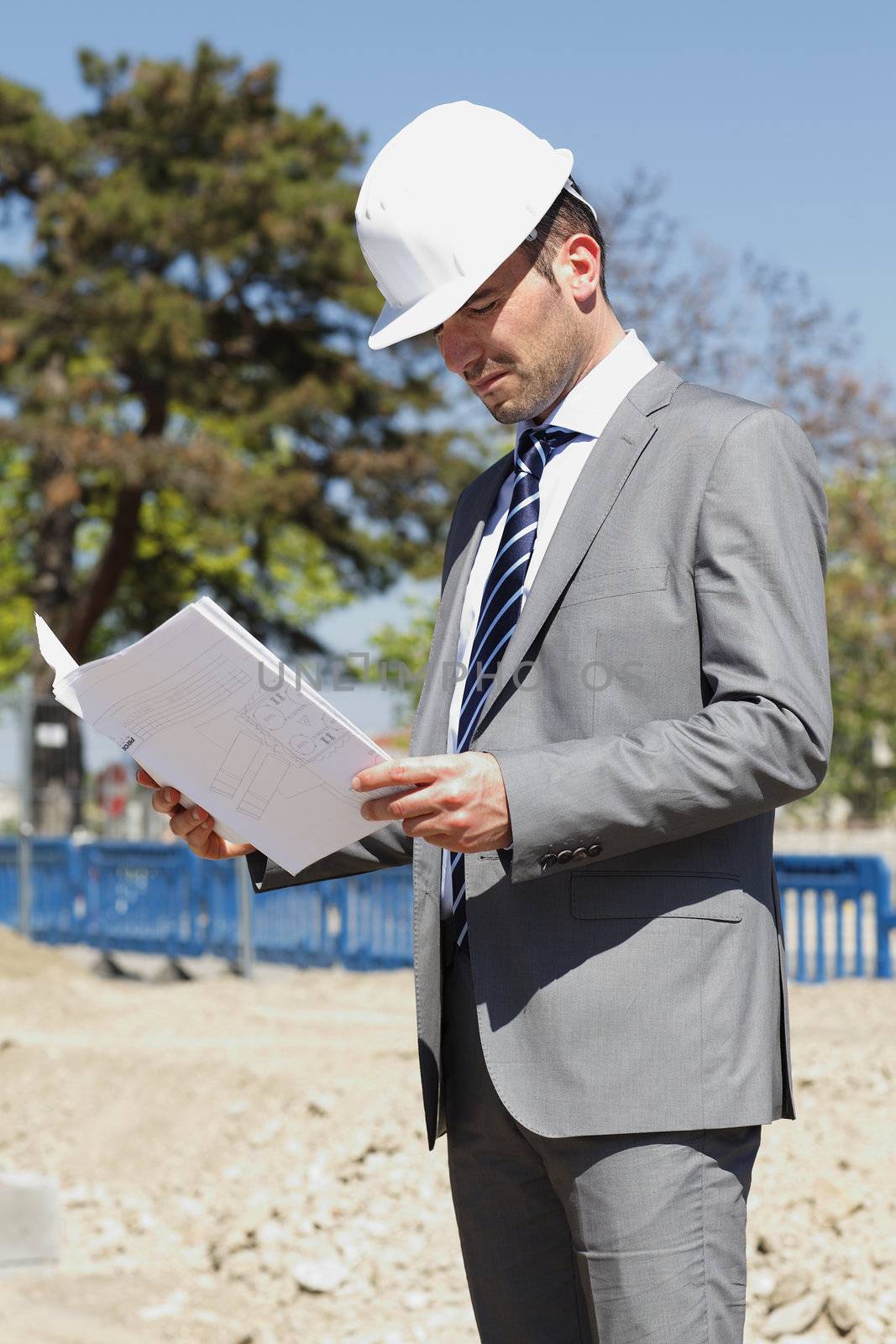 young architect on building site in summer