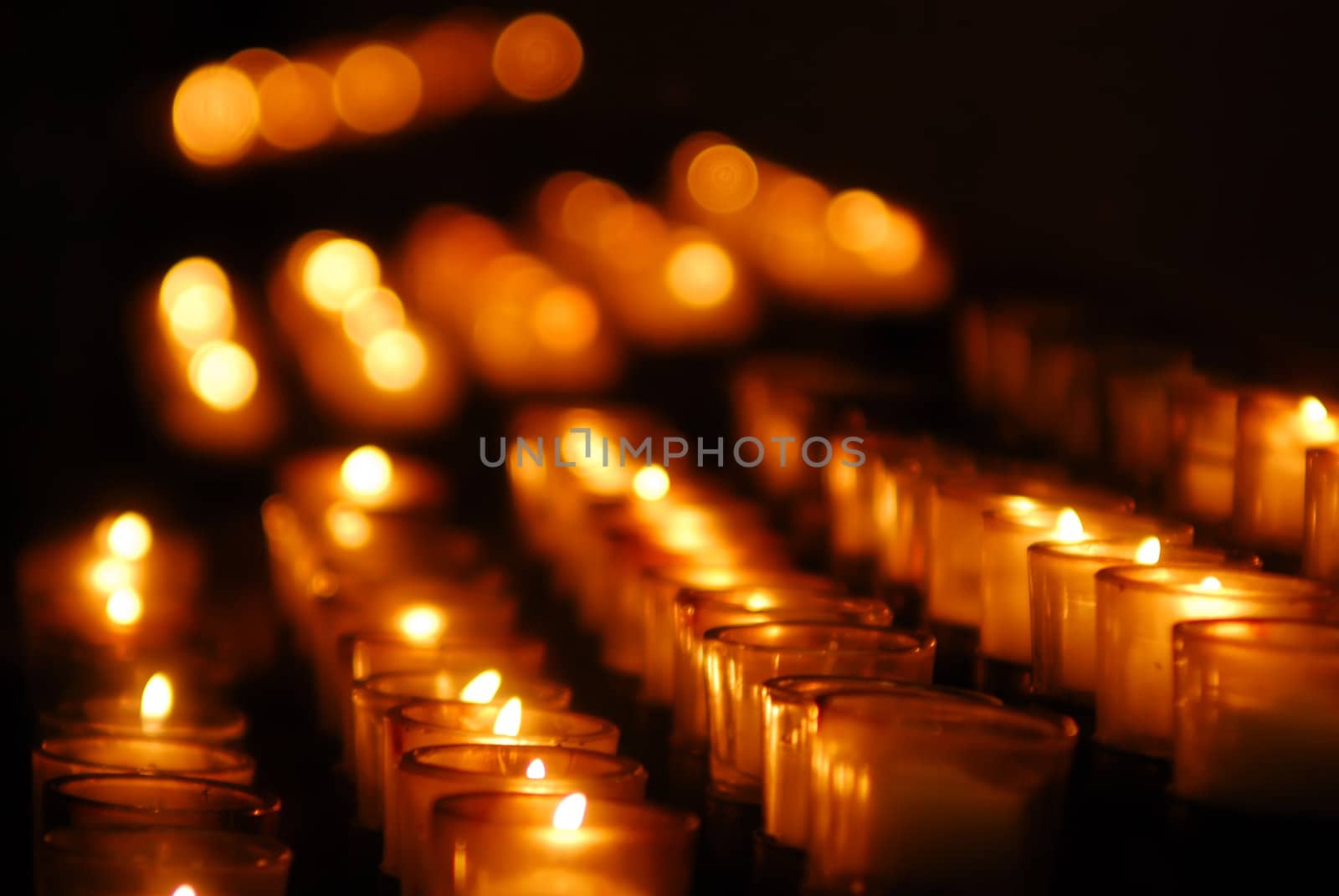 Charity. Lignting of Praying candles in a temple.