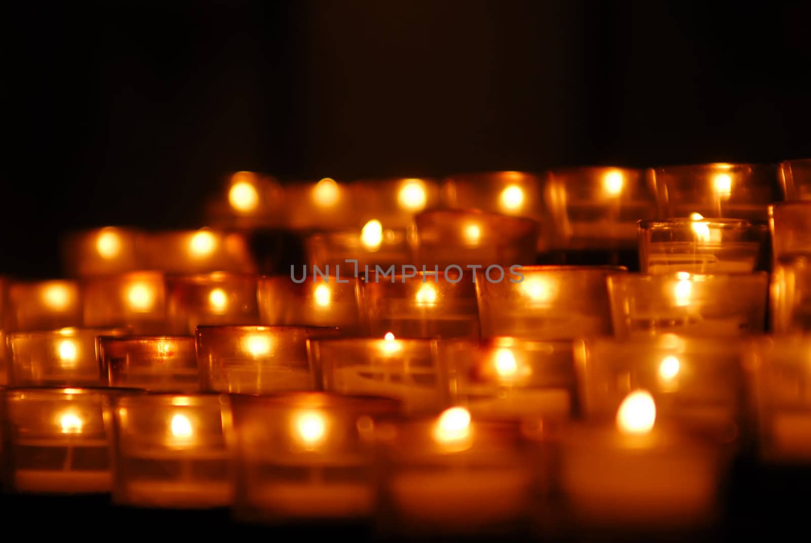 Charity. Lignting of Praying candles in a temple.