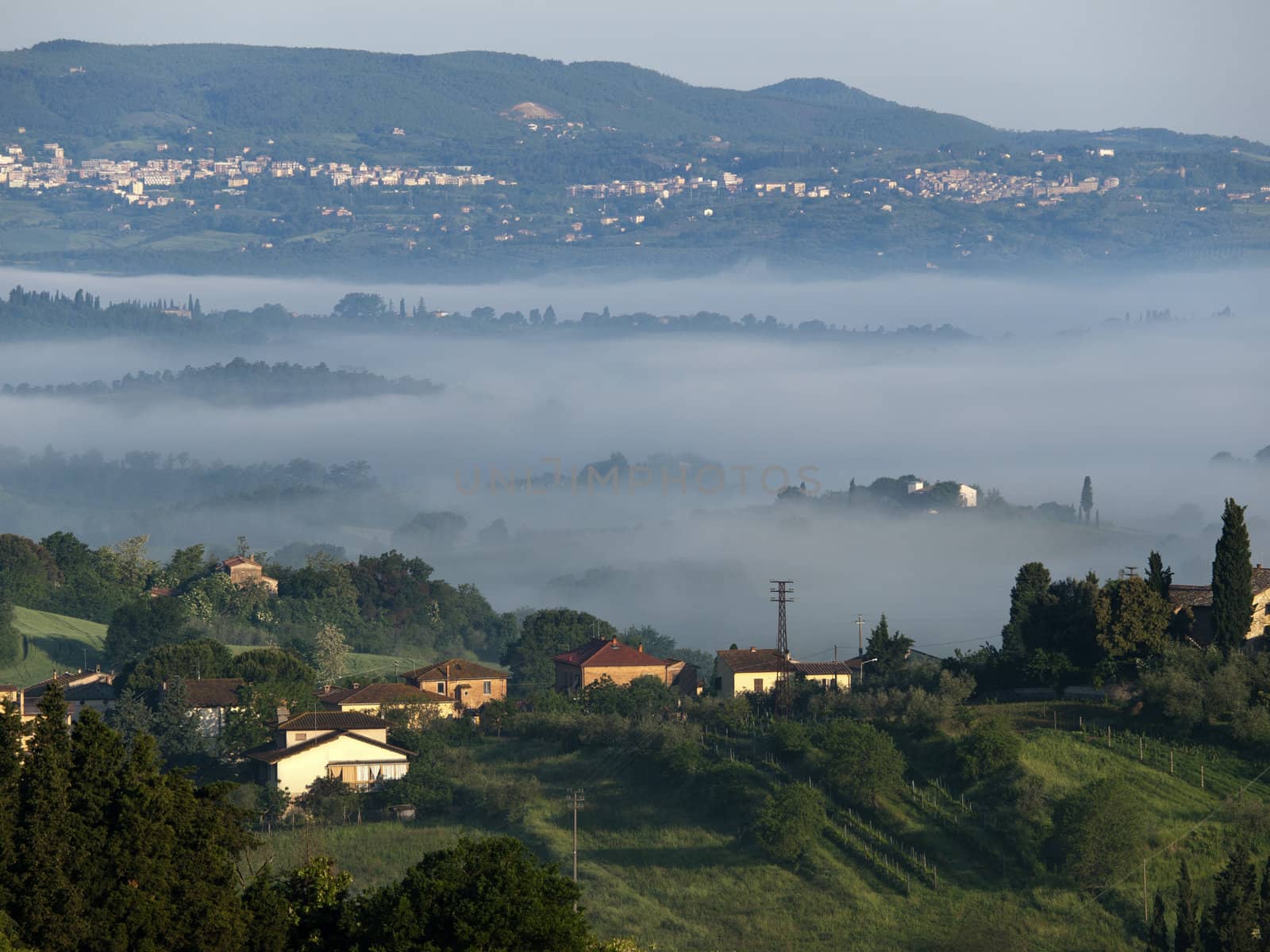 Fabulous landscape of the foggy morning in Tuscany. The valley between Montepulciano and Chiusi