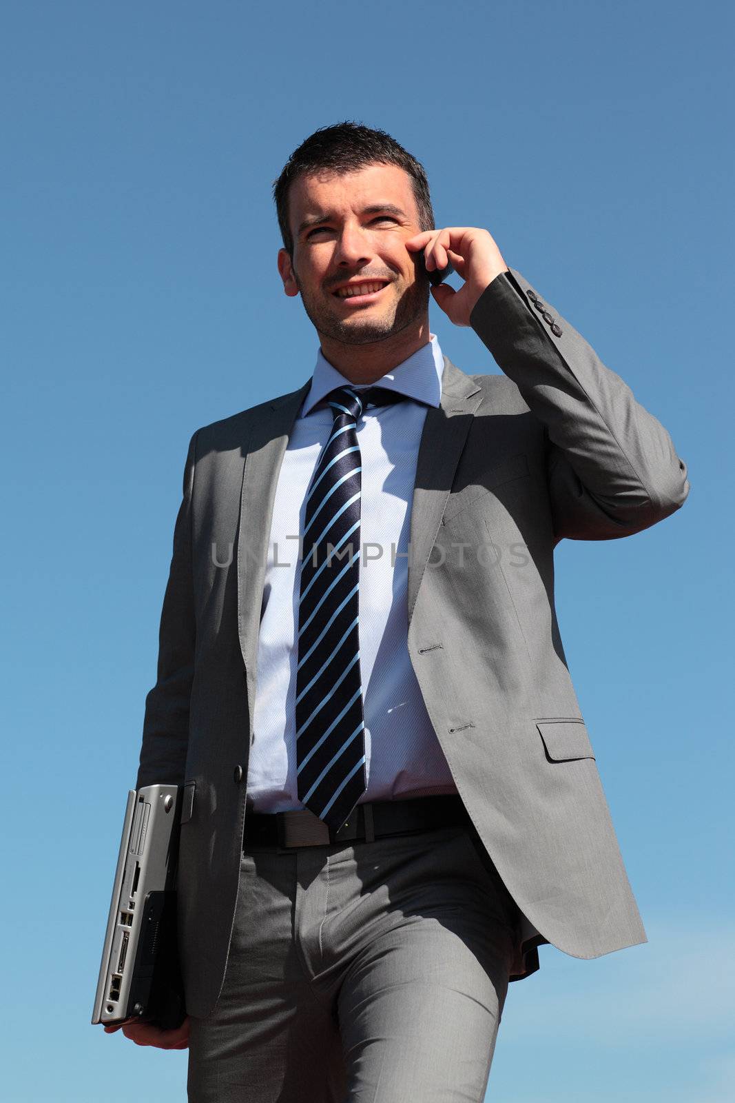 businessman on the phone in blue sky