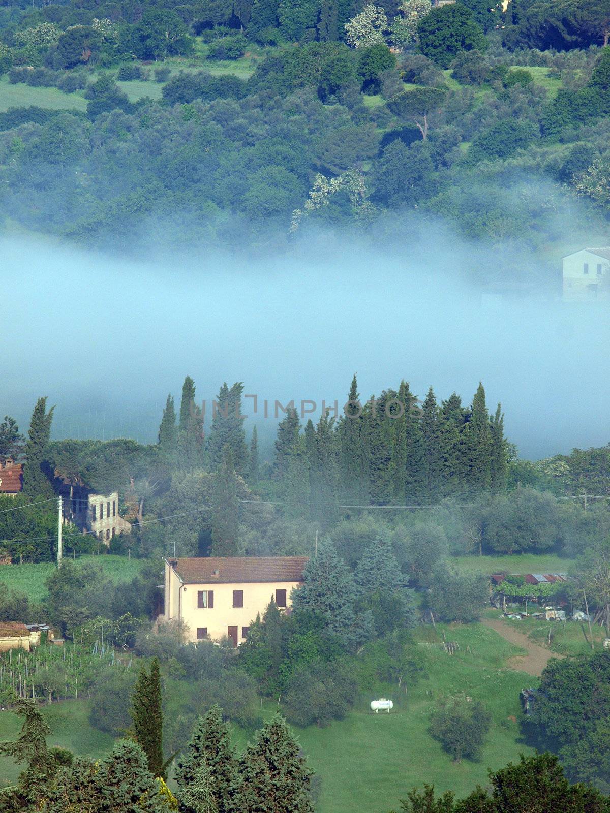 Fabulous landscape of the foggy morning in Tuscany