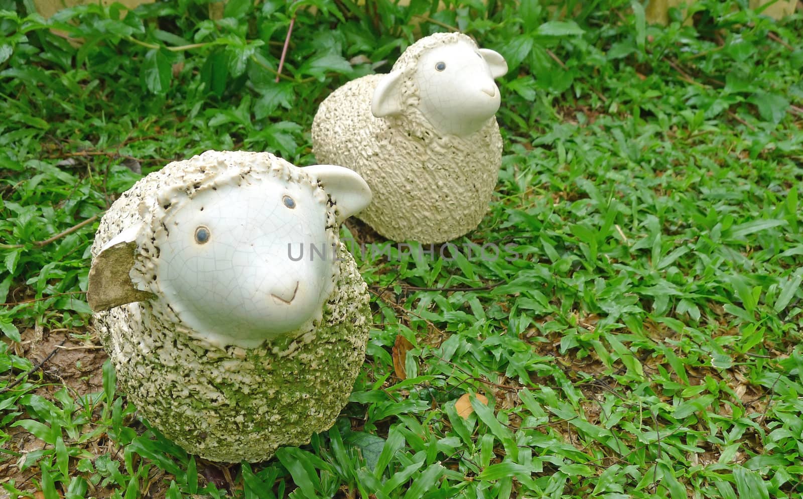 Two sheep statues decorate in a garden