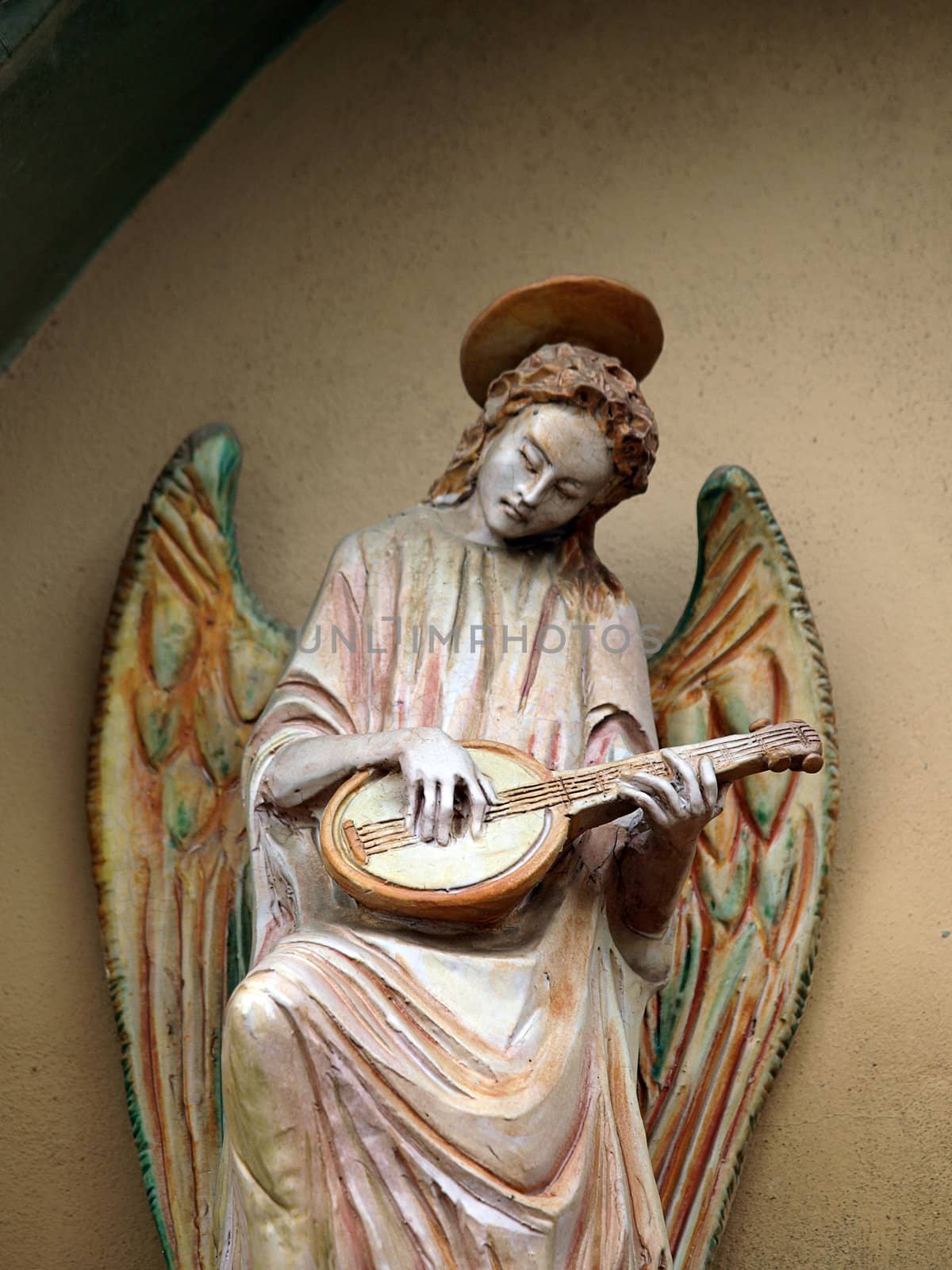 Sculpture of an angel with mandolin. Chiusi , Tuscany, Italy