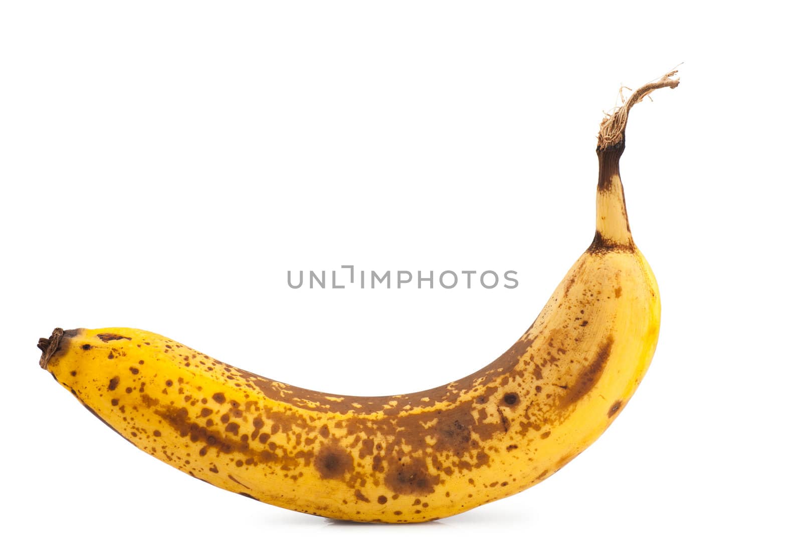 Single overripe banana isolated over white background