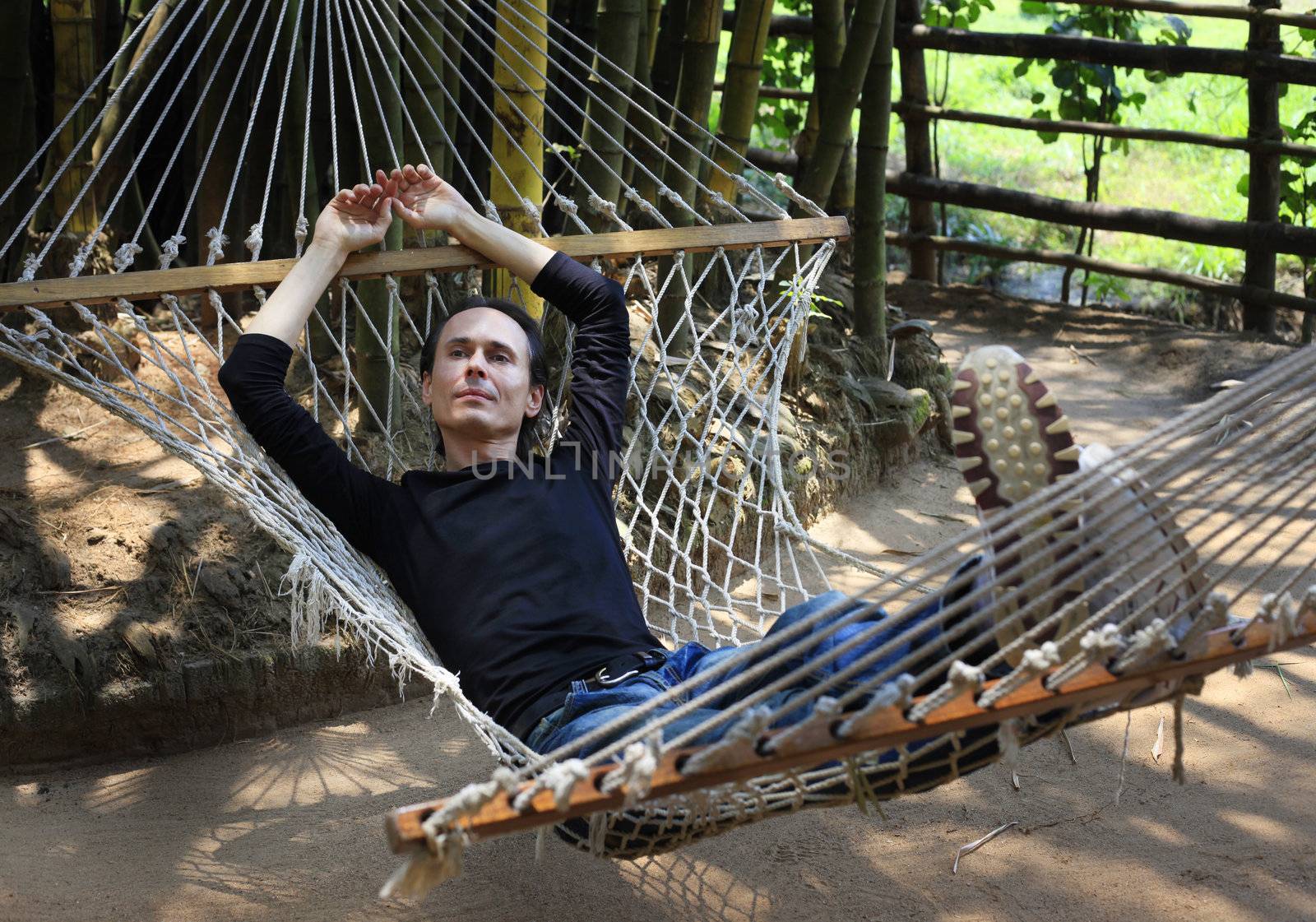 The man relaxs in a hammock