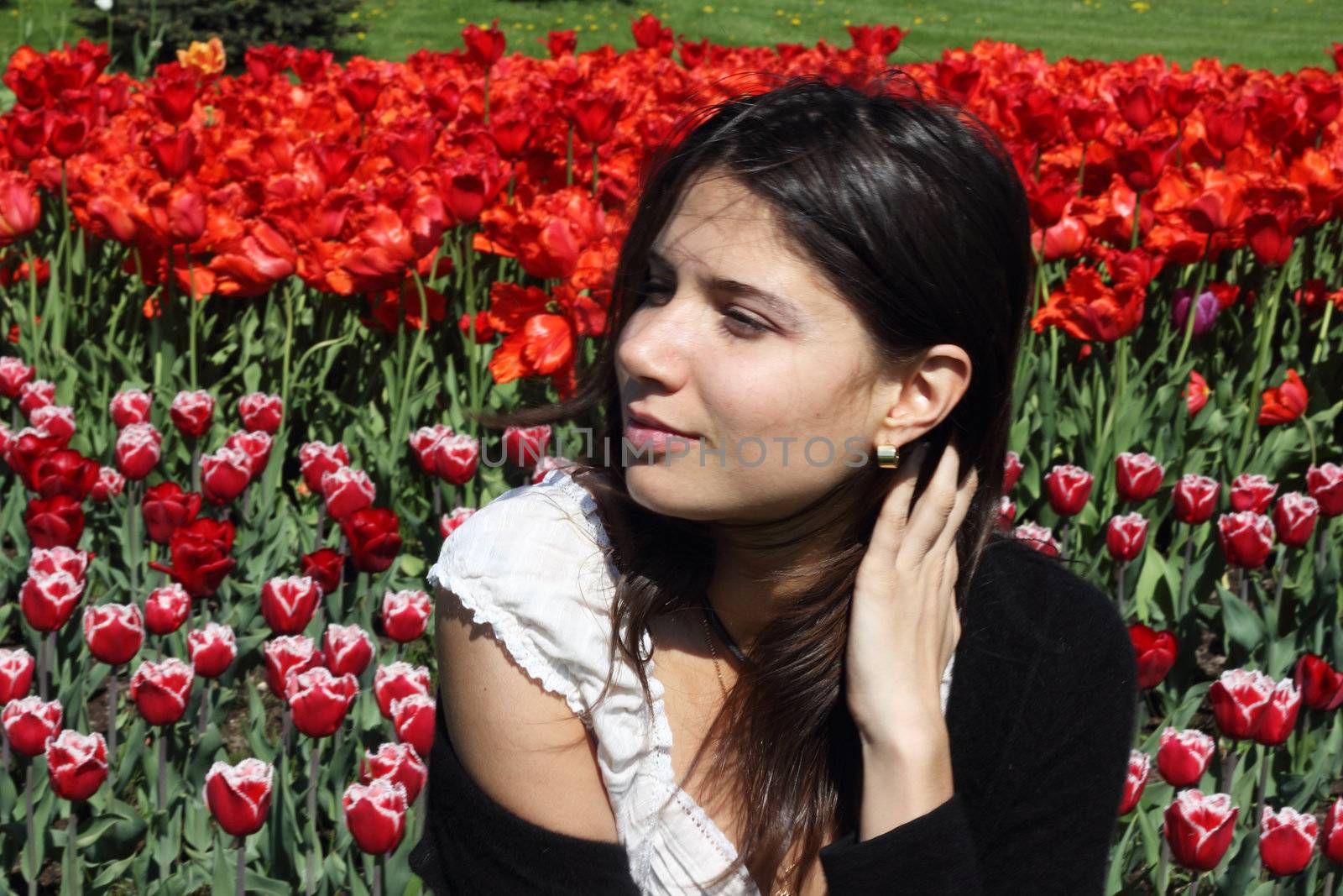 Portrait of a young woman on tulips background