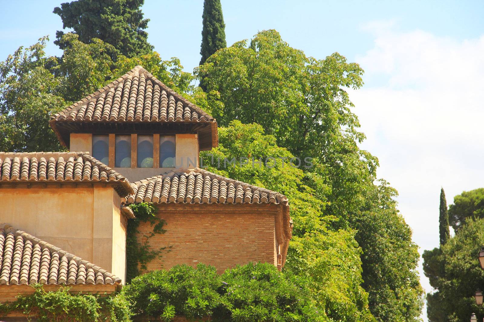 Beautiful view on ancient buildings and gardens of Alhambra