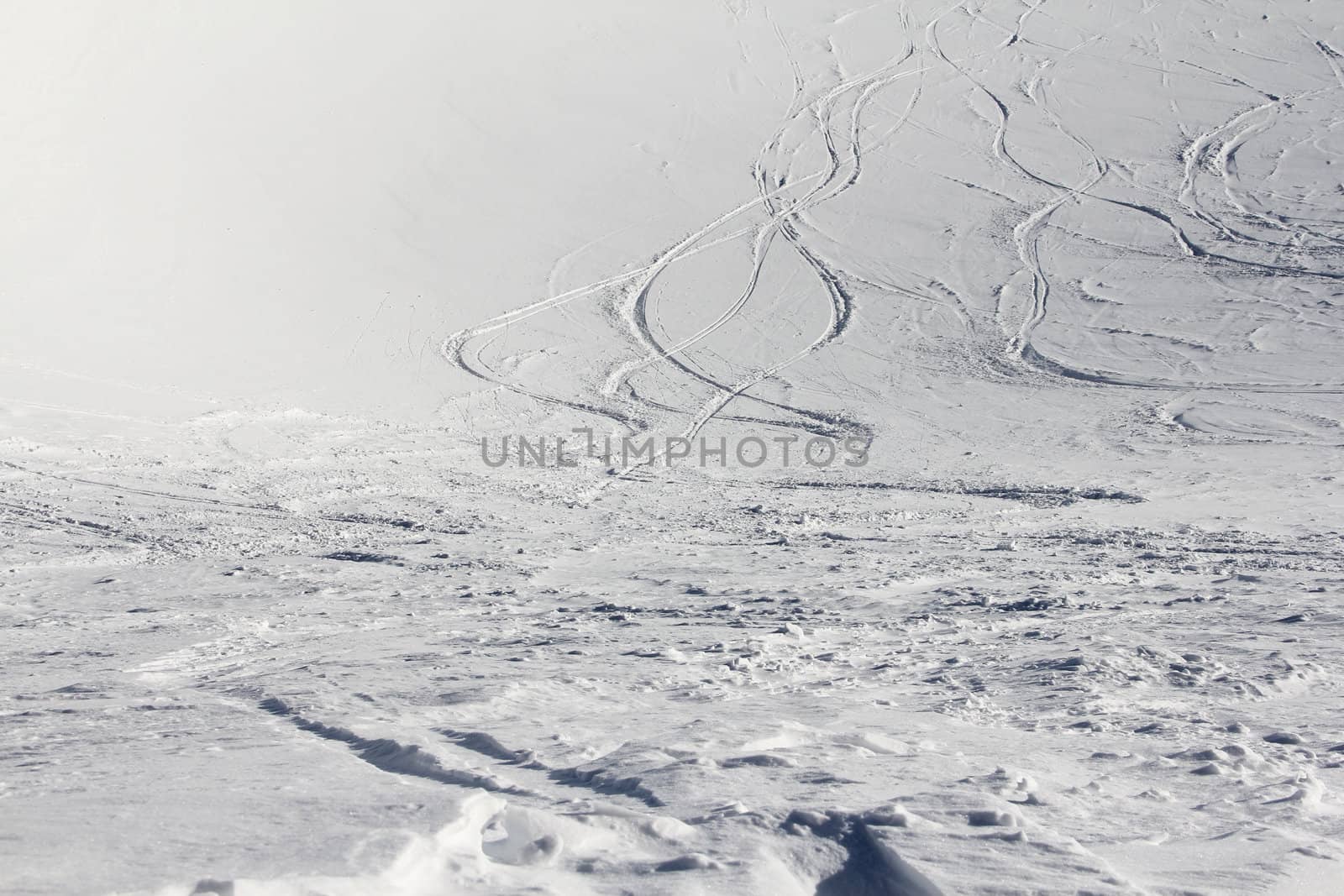 Ski traces on snow in winter mountains