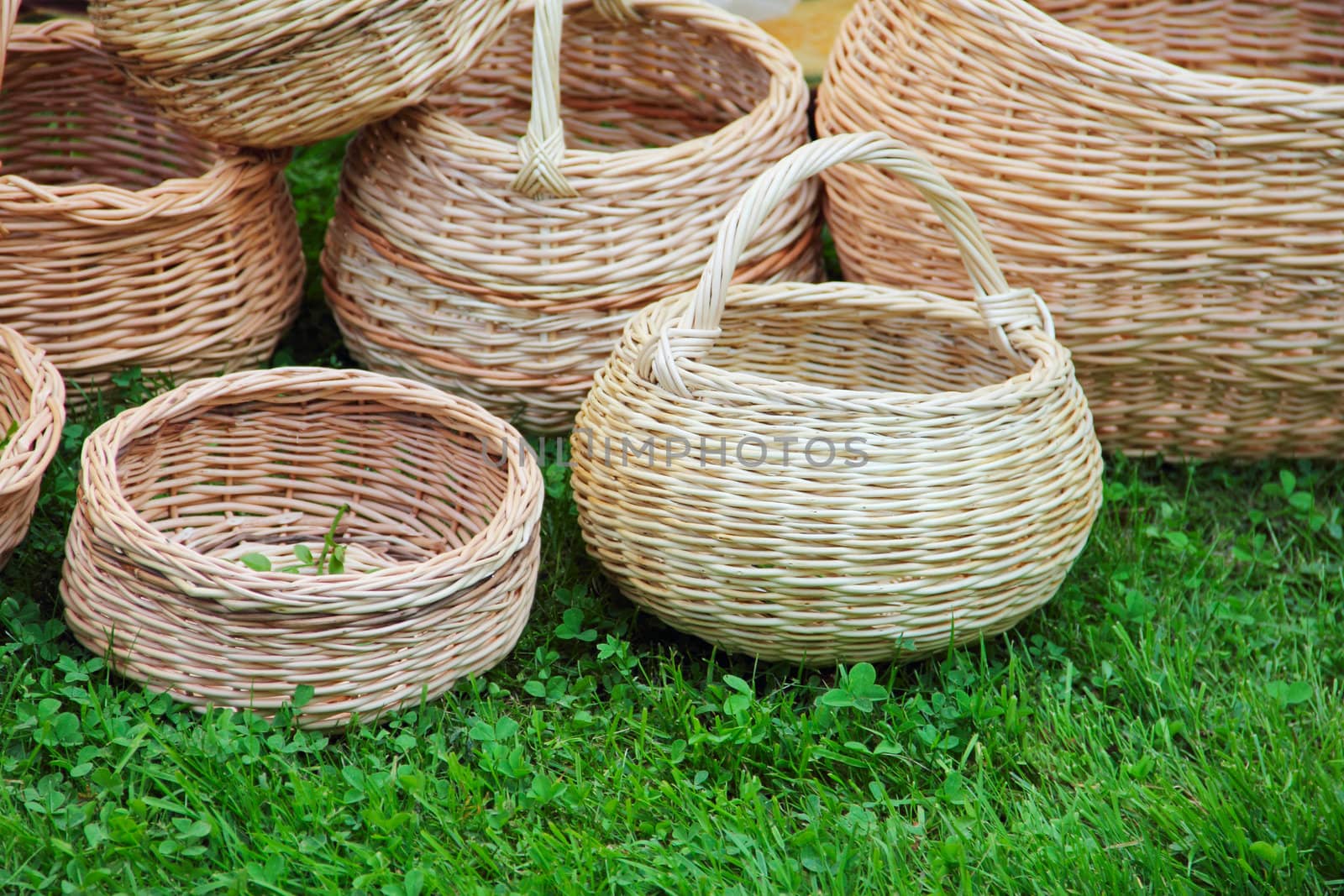 Many baskets standing on green grass outdoors fair