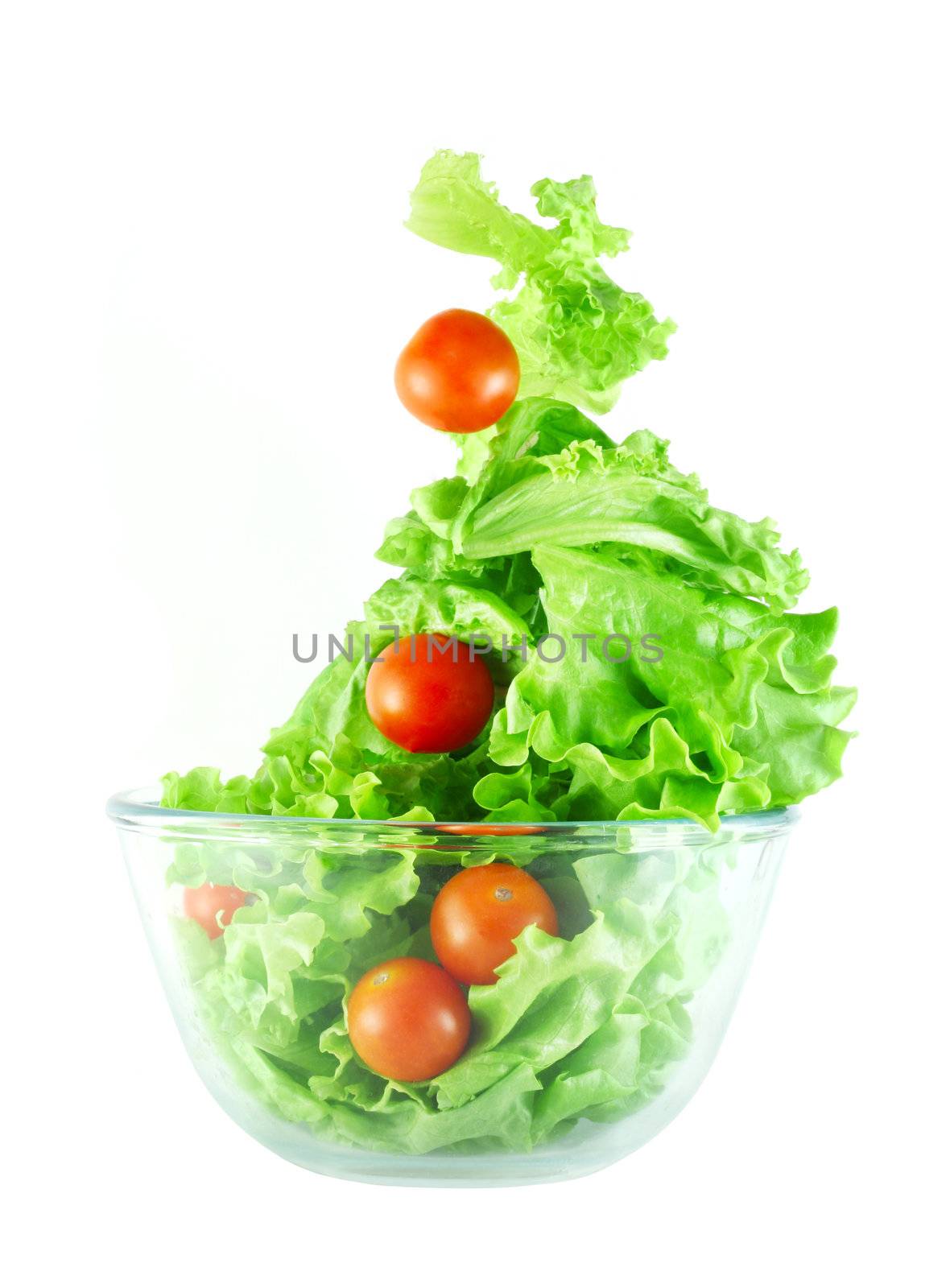  Light lettuce and cherry tomatoes salad in transparent bowl isolated on white lightness concept