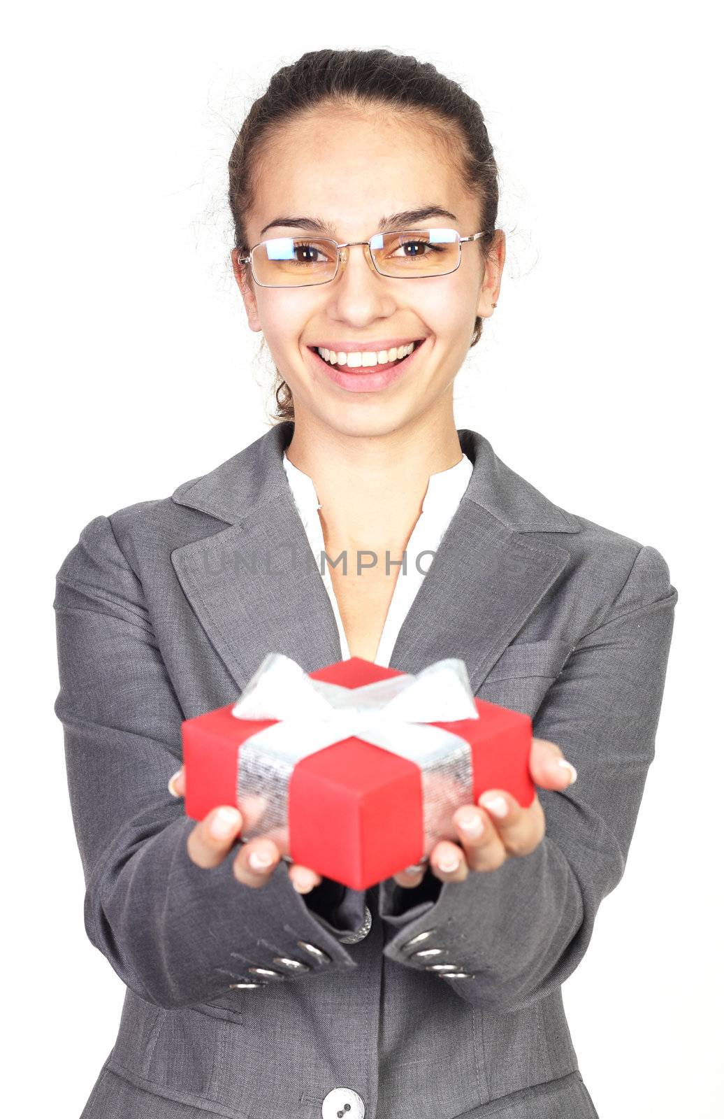 Businesswoman giving you a gift isolated on white