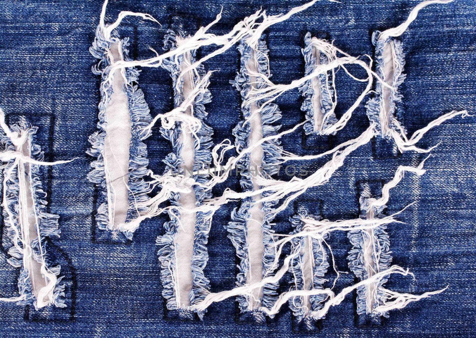 Creative embroidery on jeans, denim background