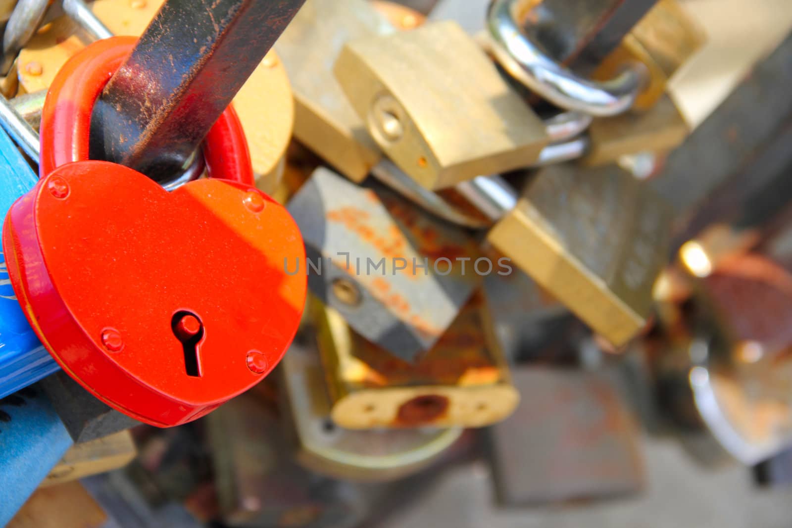 Many marriage love symbol padlocks chained on bridge