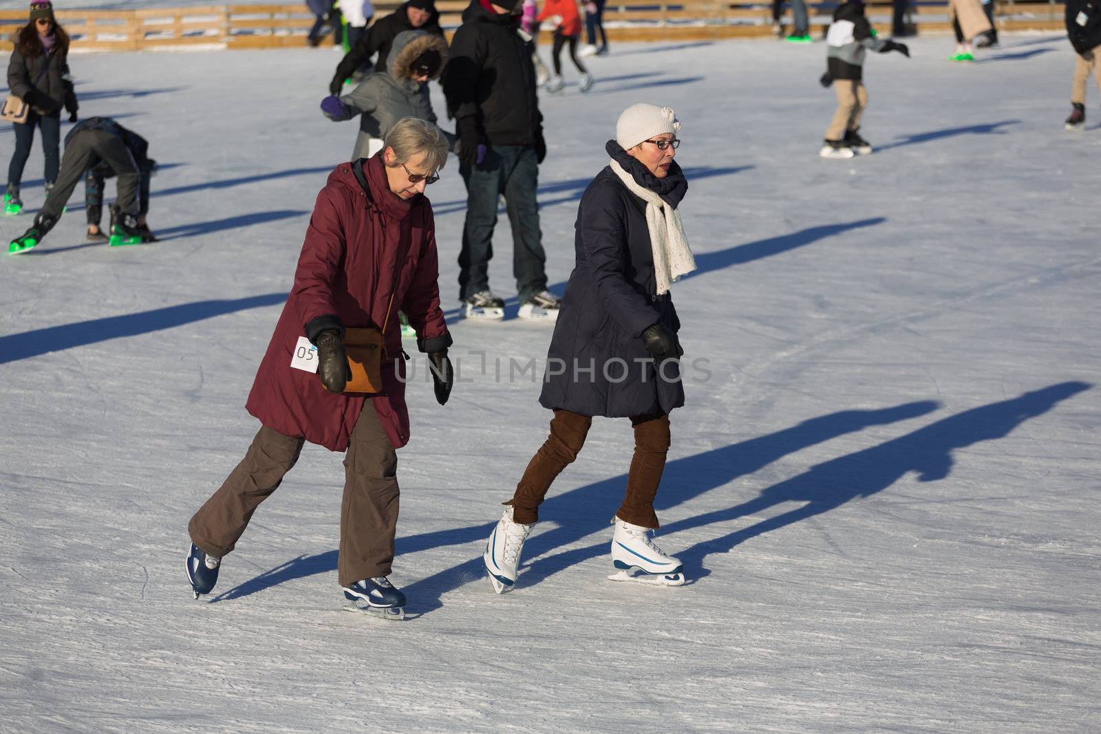  Two elder women ice skating by petkolophoto