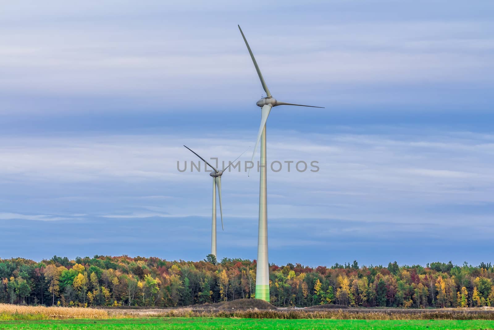 Wind turbine in a field in an amazing summer evening, producing wind, Canada