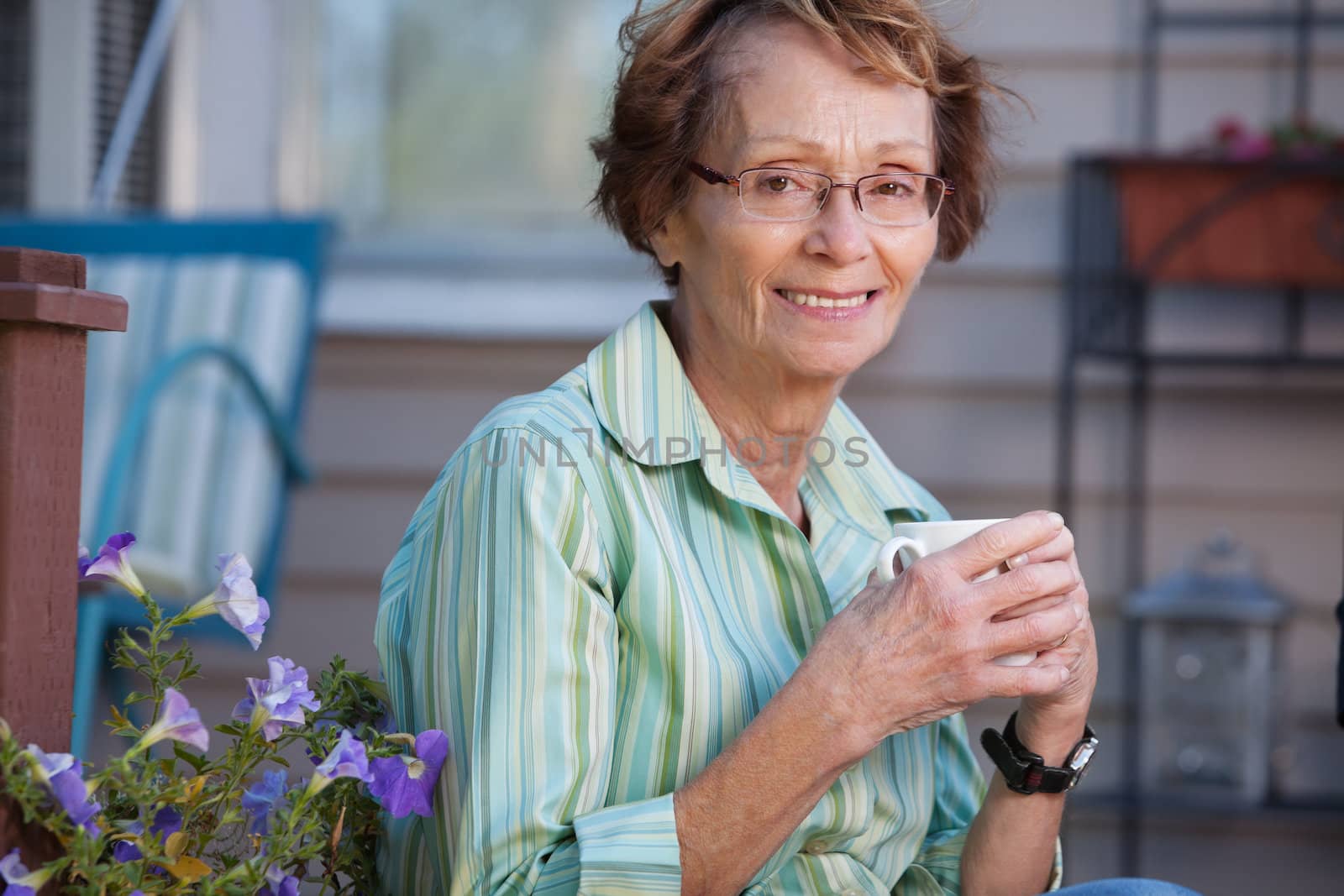 Portrait of smiling senior woman enjoying a warm drink
