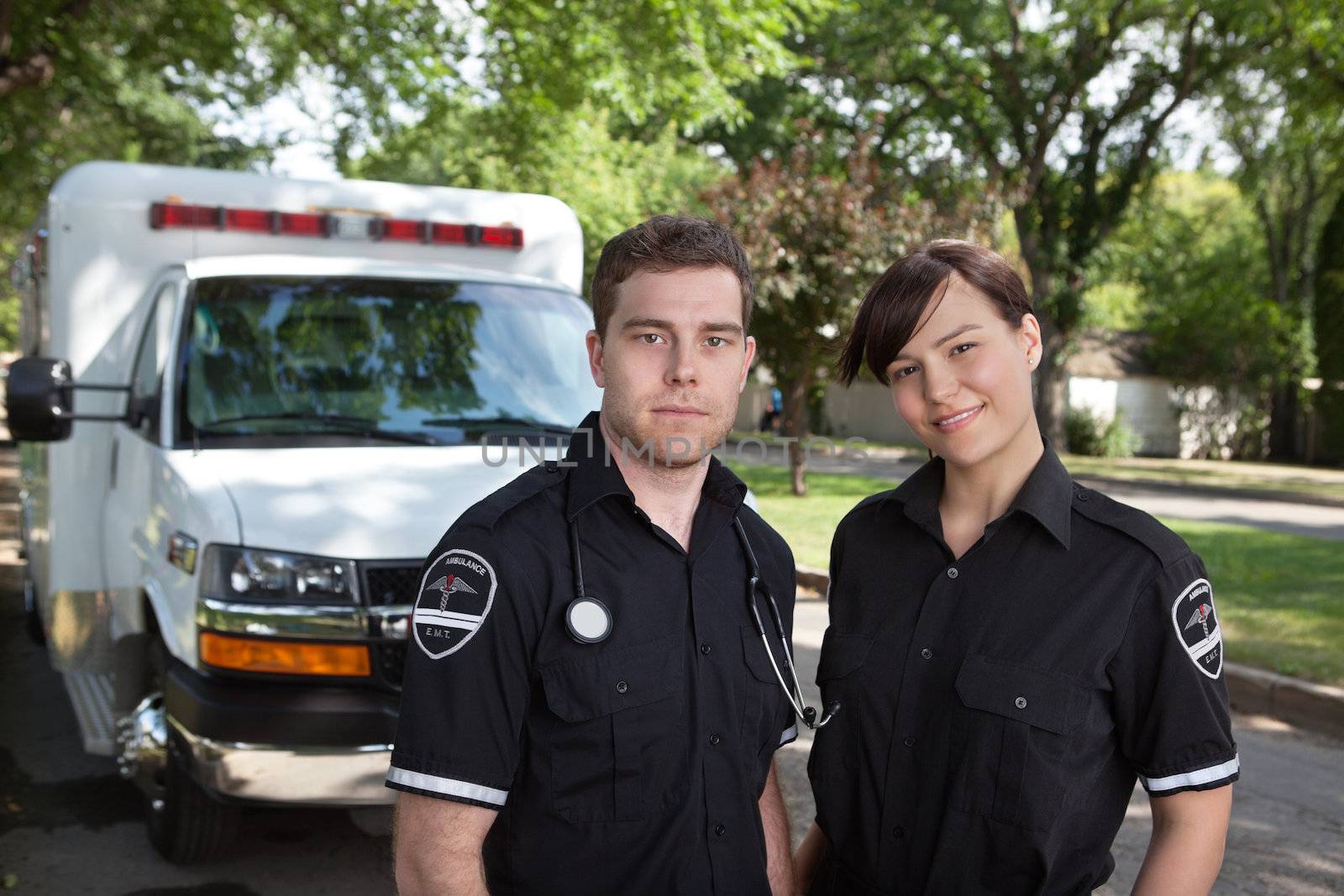 Paramedic team portrait with ambulance in background