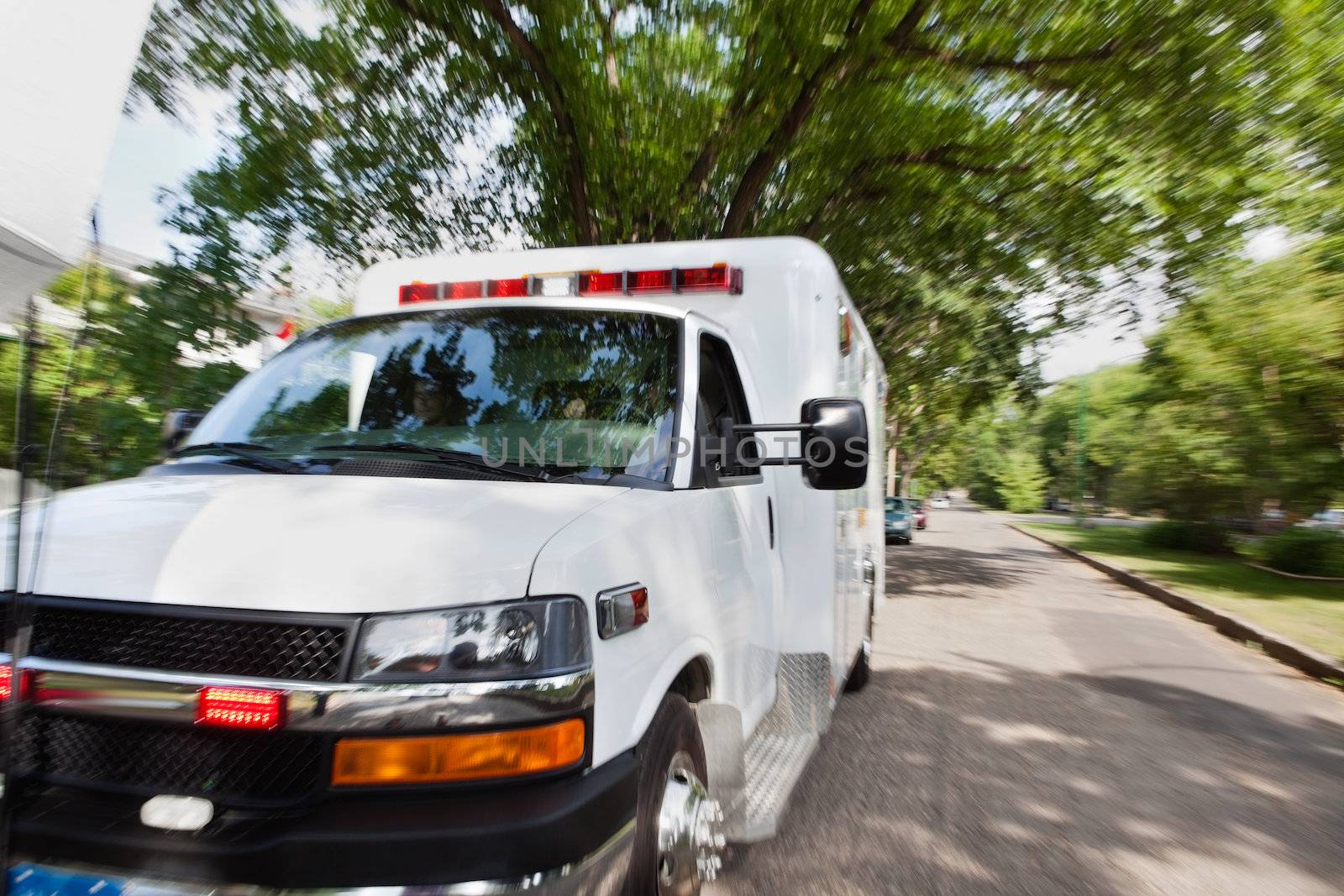 Ambulance vehicle travelling to accident, motion blur to give sense of speed