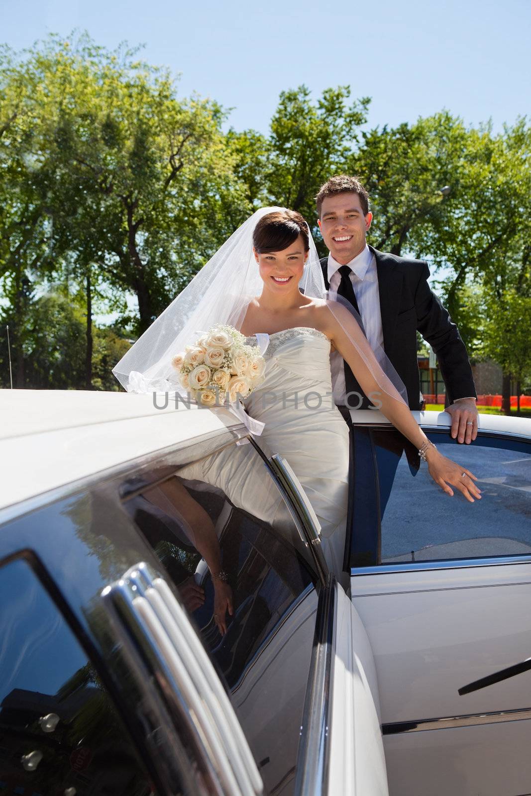 Wedding Couple with Limousine by leaf