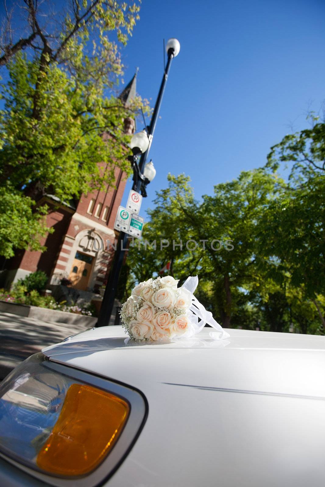 Wedding flowers on car parked in front of church