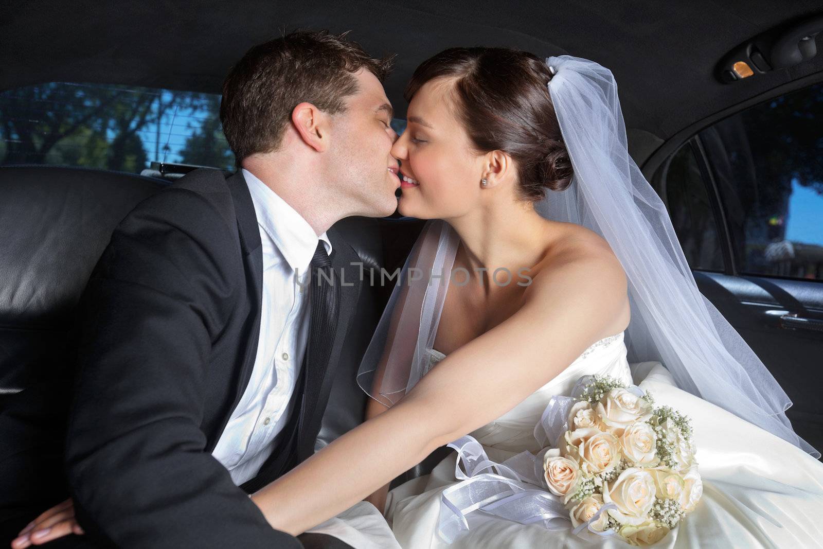 Wedding Couple Kiss in Limo by leaf