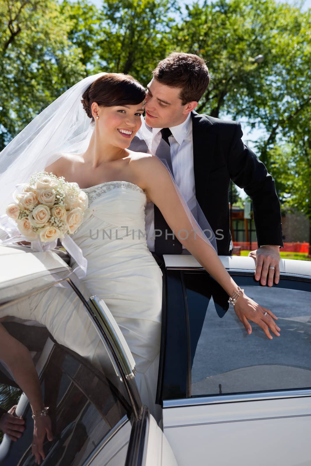 Wedding couple in Limo, groom about to kiss bride
