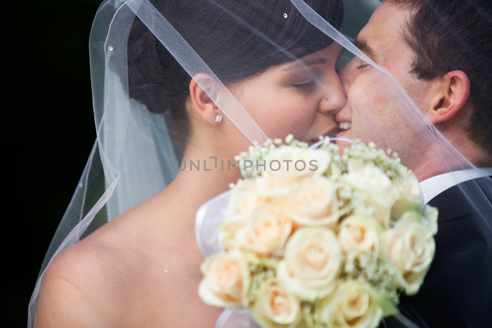 Happy Married Couple Kissing by leaf