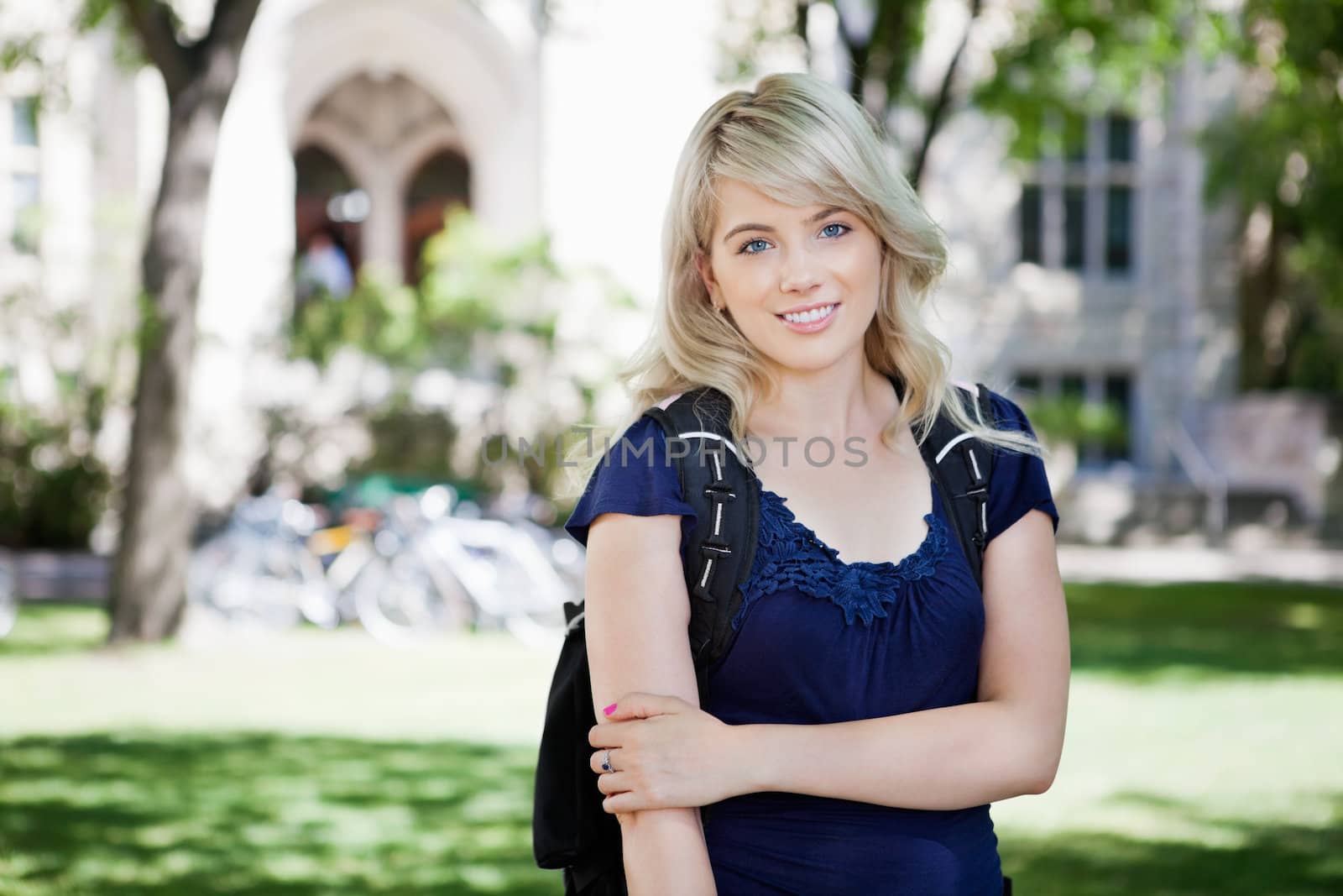 Portrait of a beautiful young girl standing in the campus